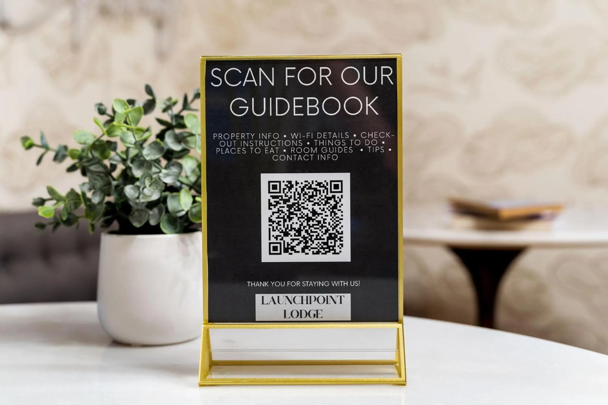 Property logo or sign in Launchpoint Lodge