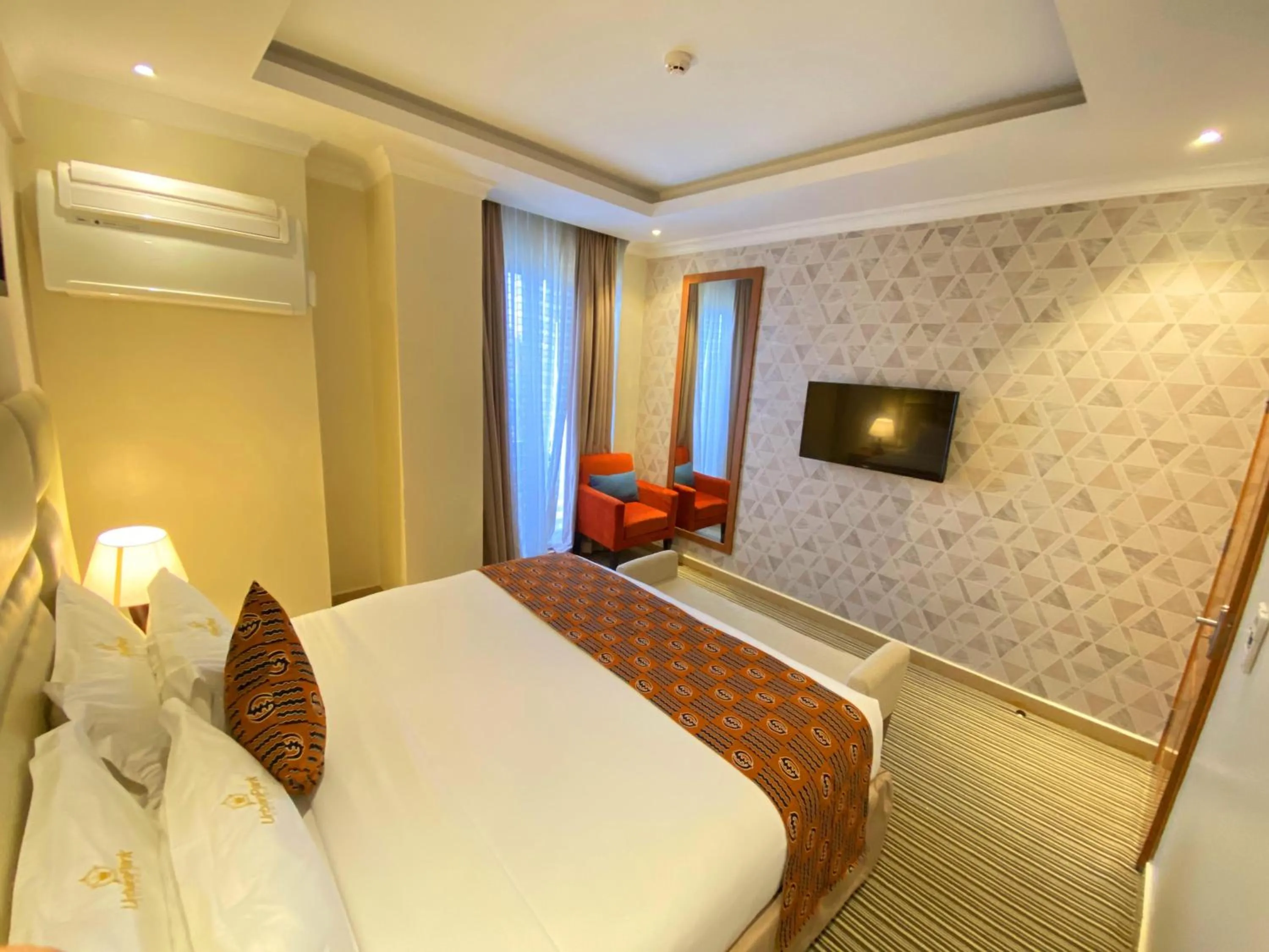 Bed in Urban Park Suites Hotel