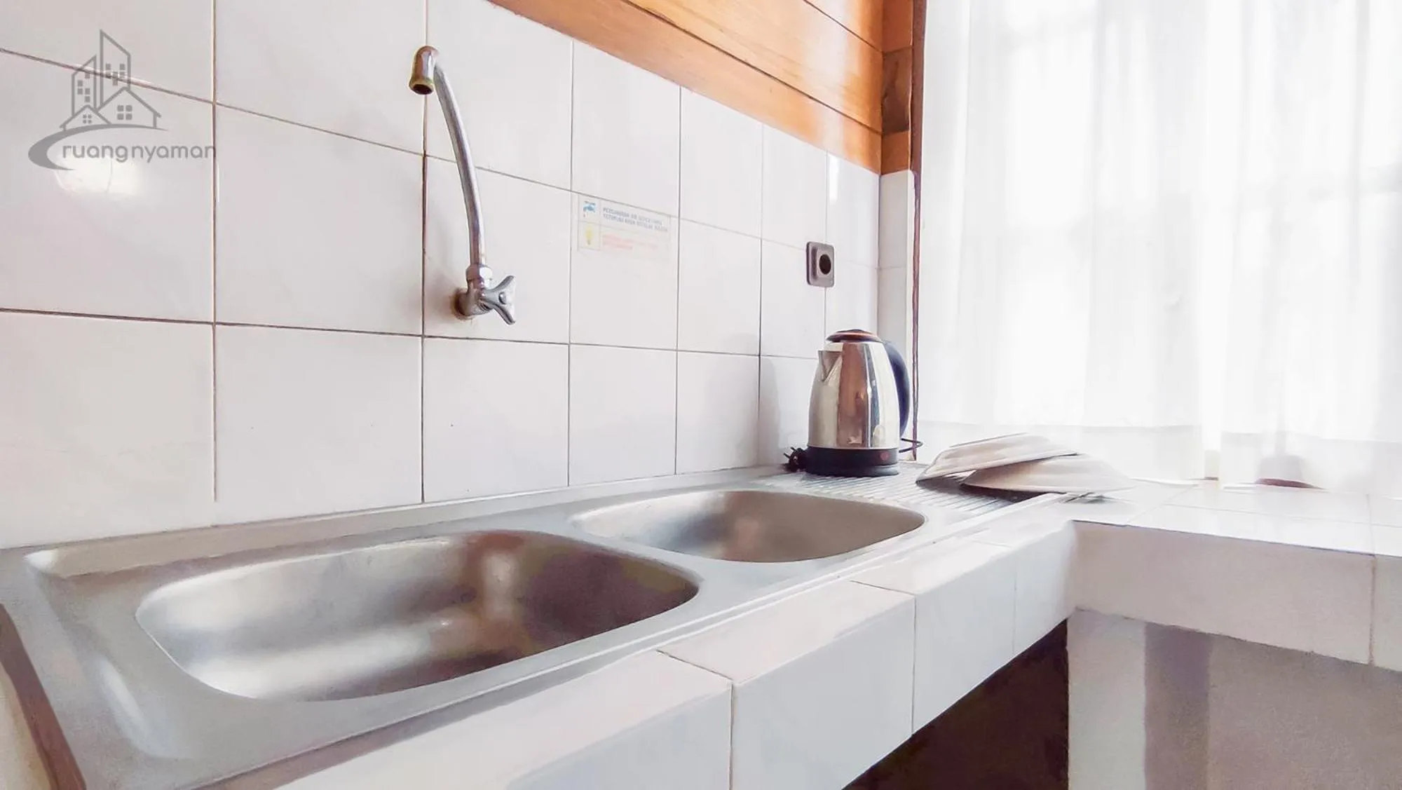 Kitchen or kitchenette in Sukanagalih Resort by Ruang Nyaman