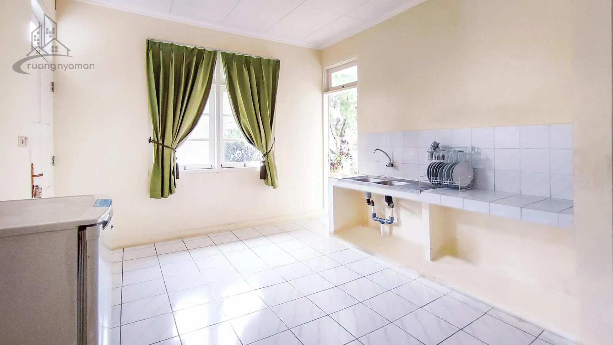 Kitchen or kitchenette in Sukanagalih Resort by Ruang Nyaman