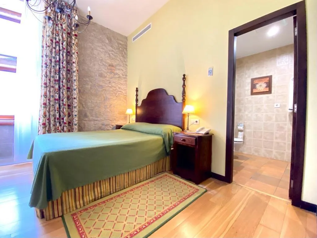Bed in Hotel Pazo de Lestrove by Pousadas de Compostela