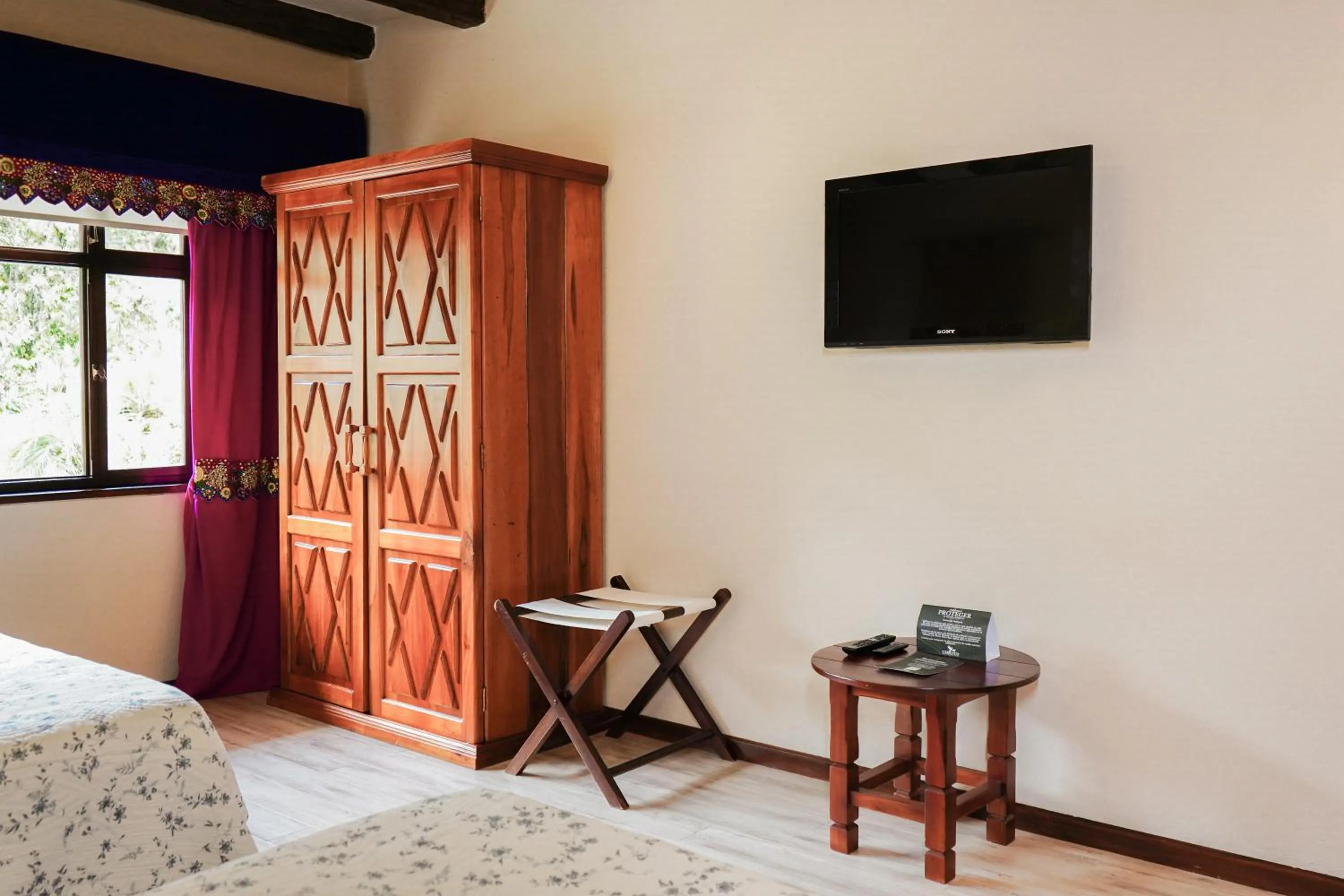 Communal lounge/ TV room, Bed in Uzhupud Garden Hotel & Lodge