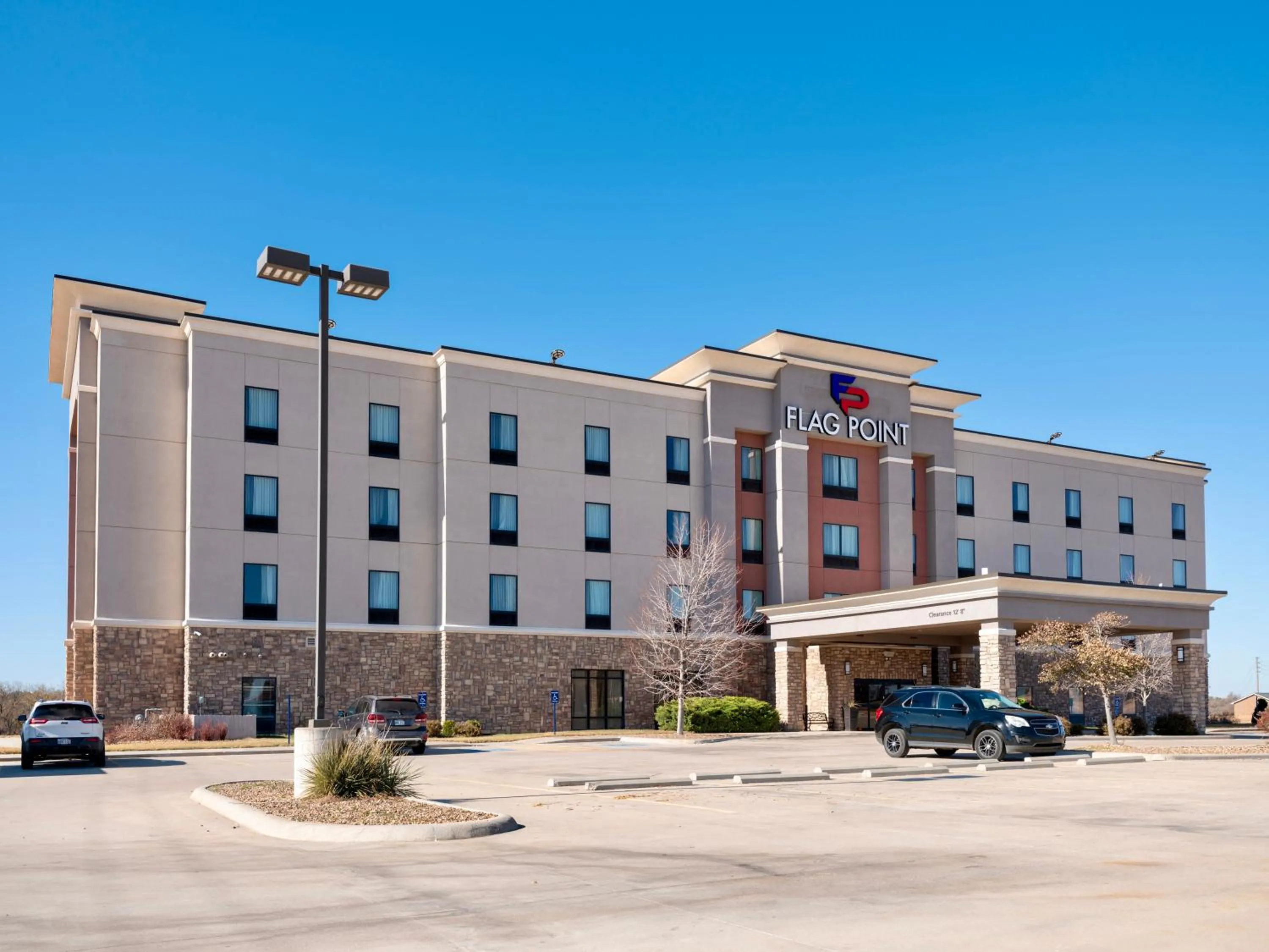 Property building in Flag Point Inn and Suites Pratt by FairBridge