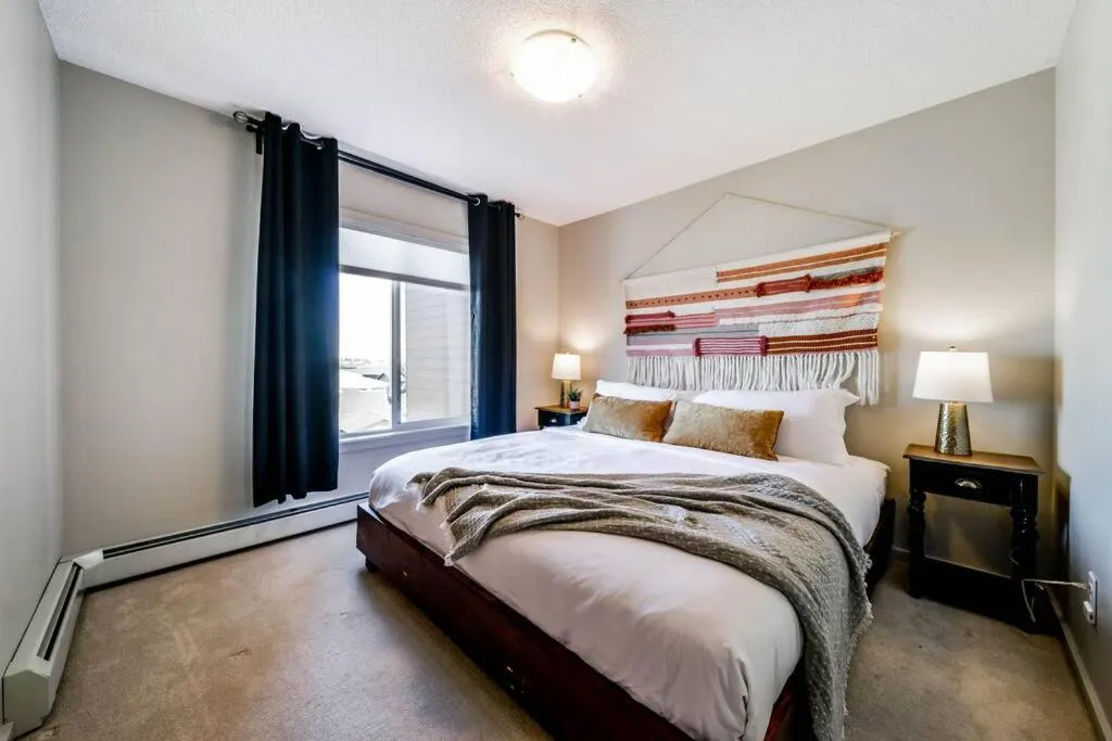 Bed in Bright Luxe Condo, AC, Top Floor, King Bed, Balcony!