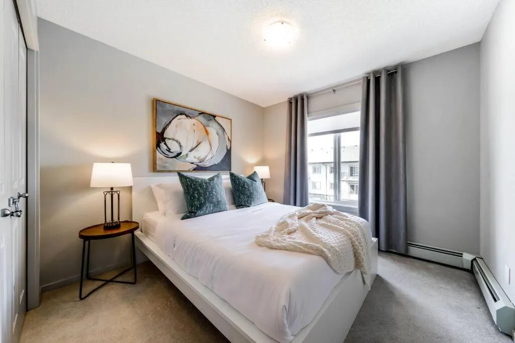 Bed in Bright Luxe Condo, AC, Top Floor, King Bed, Balcony!
