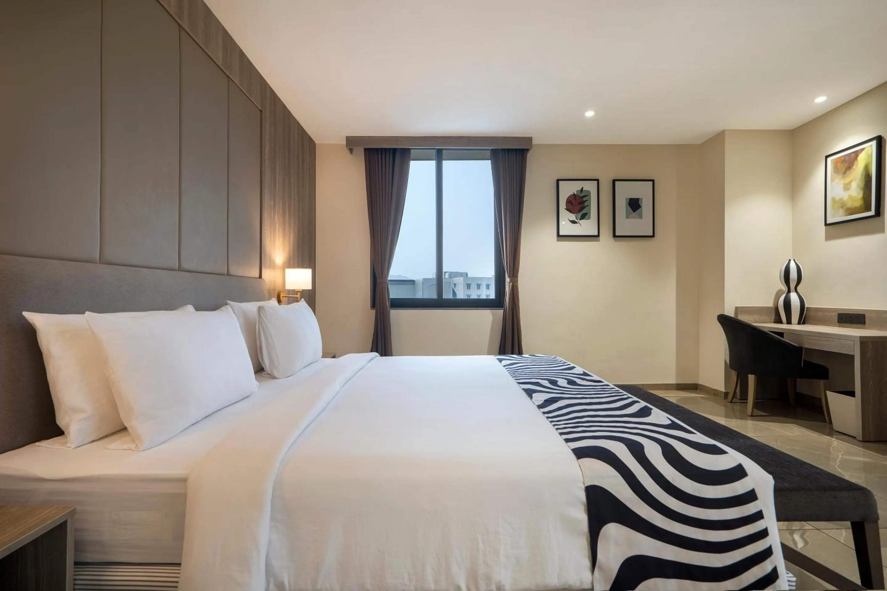 Photo of the whole room, Bed in Sunday Hotel by CheckIn Vadodara