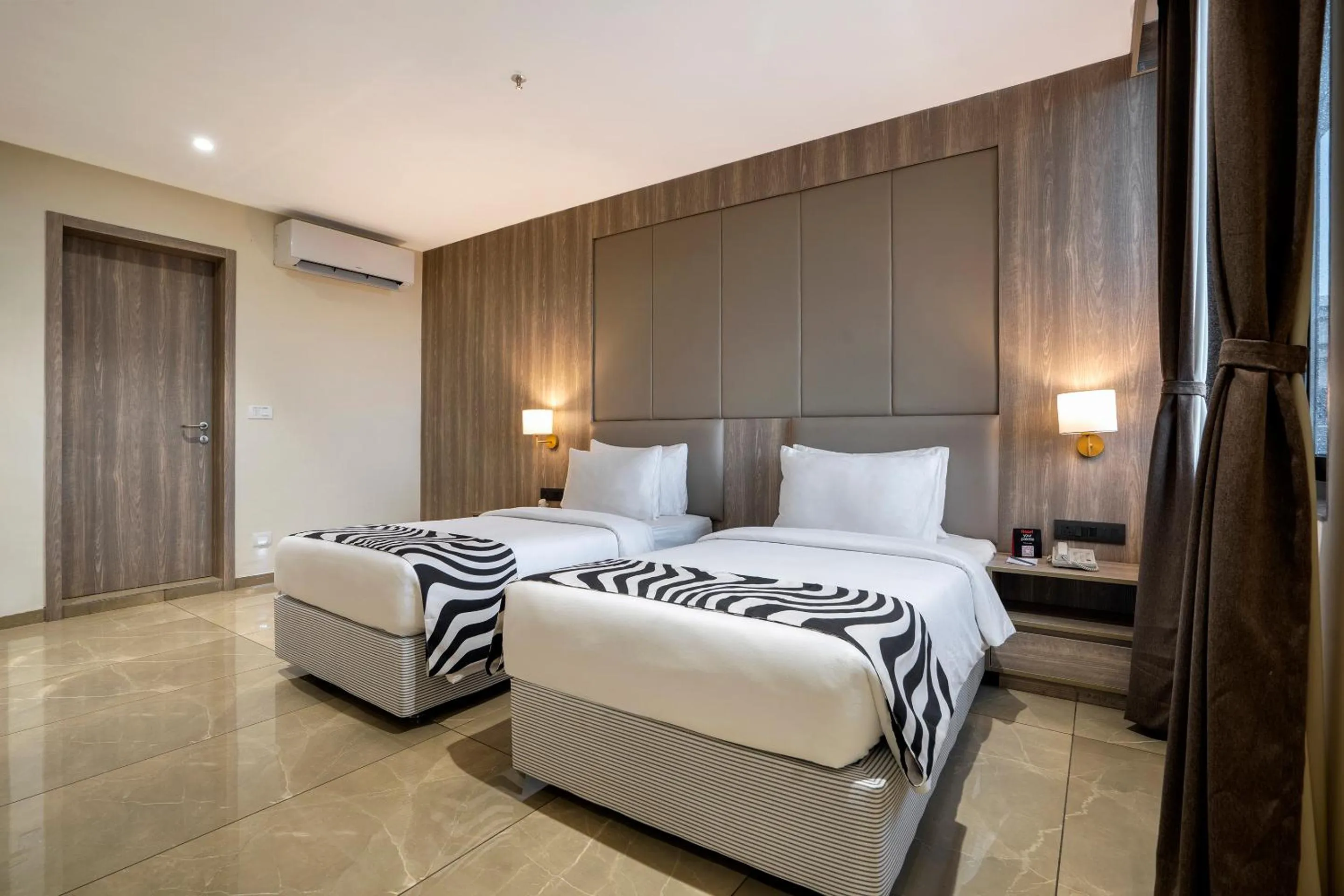 Bed in Sunday Hotel by CheckIn Vadodara