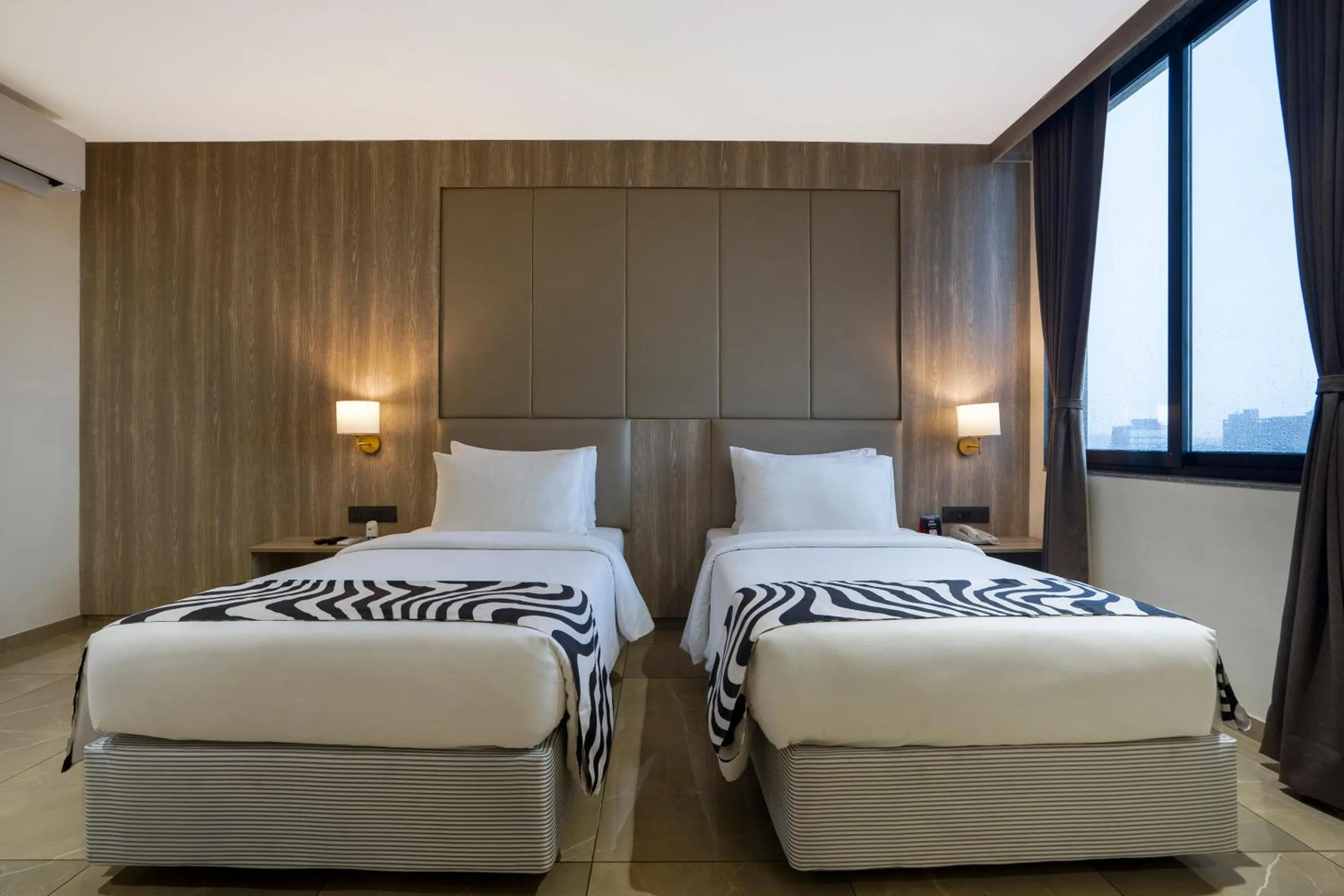 Bed in Sunday Hotel by CheckIn Vadodara