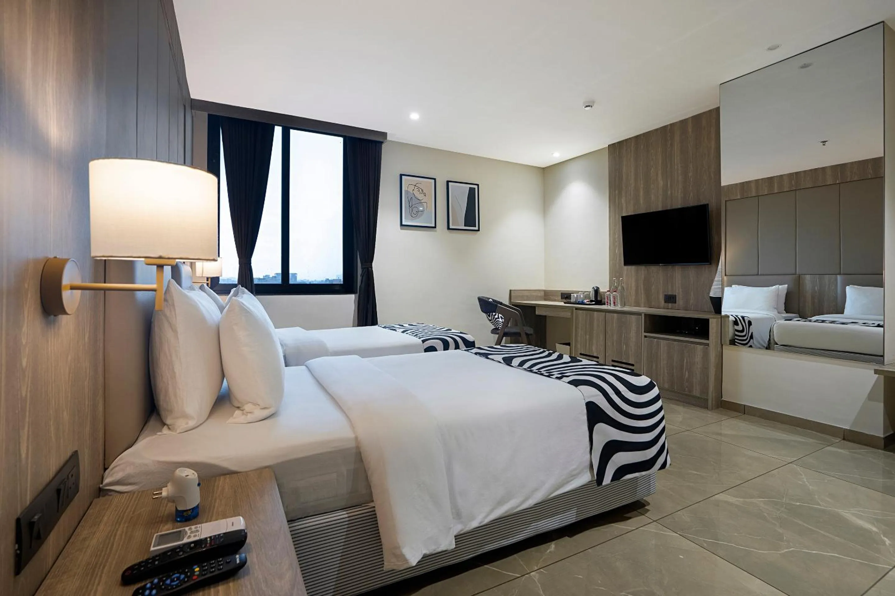 Photo of the whole room, Bed in Sunday Hotel by CheckIn Vadodara