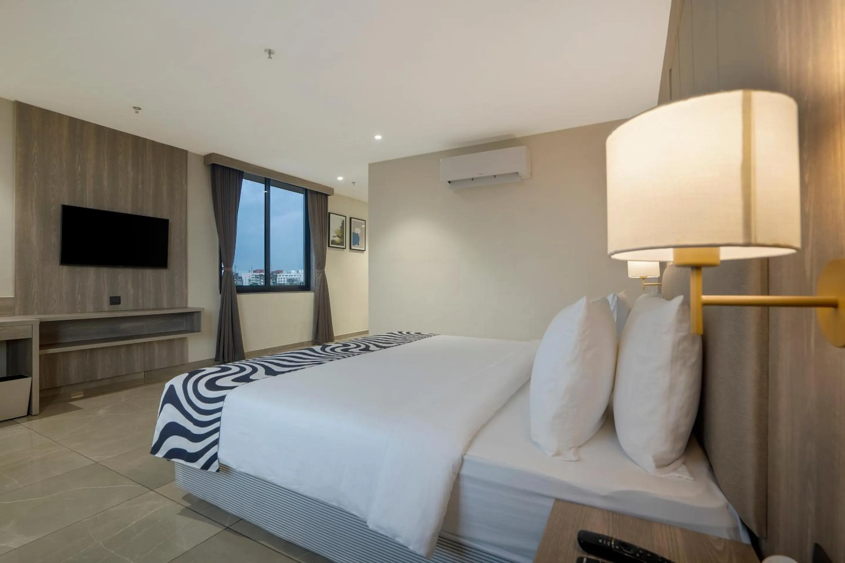 Photo of the whole room, Bed in Sunday Hotel by CheckIn Vadodara