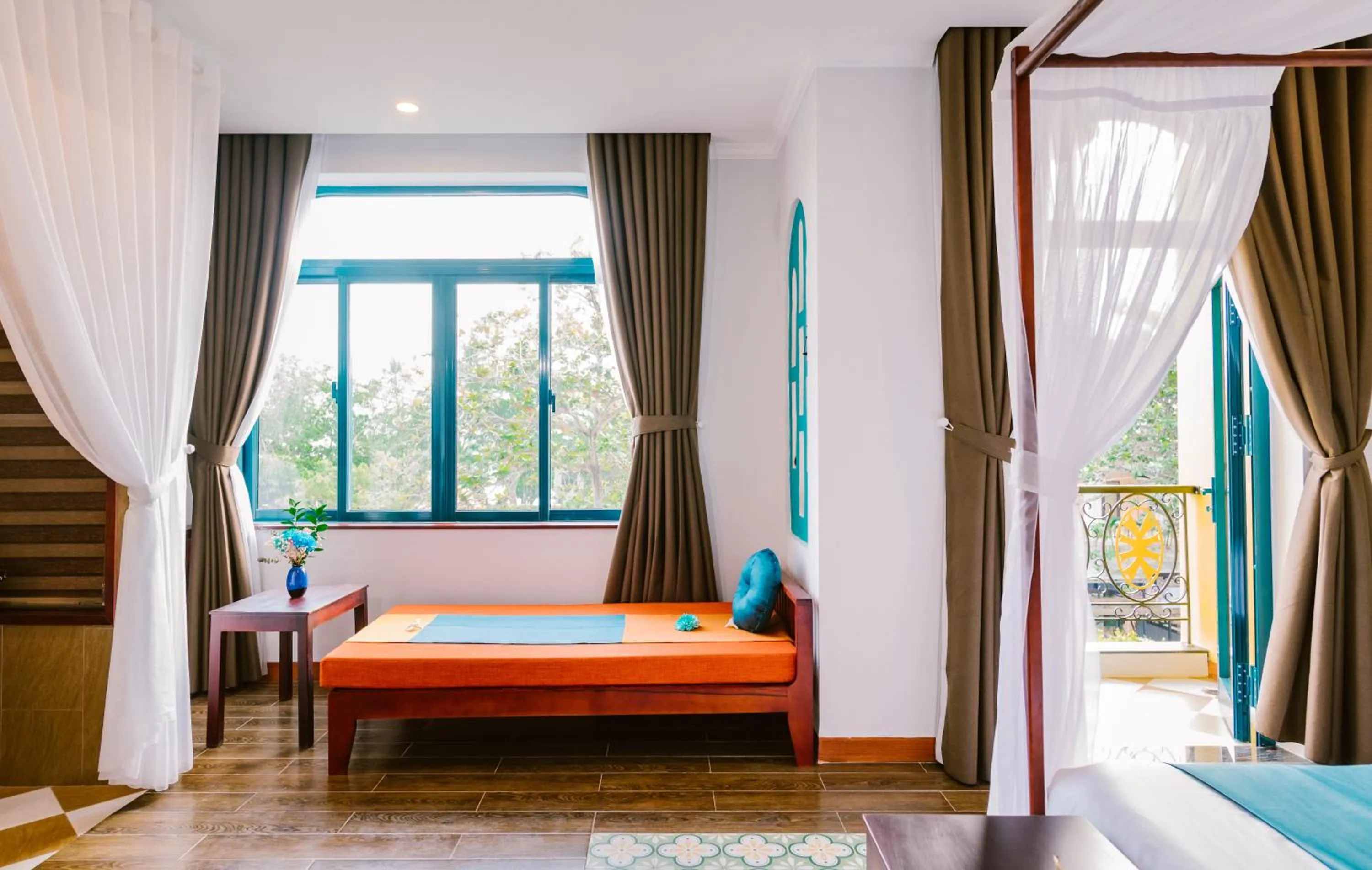 Seating area, Bed in De'Colore Villa Hoi An