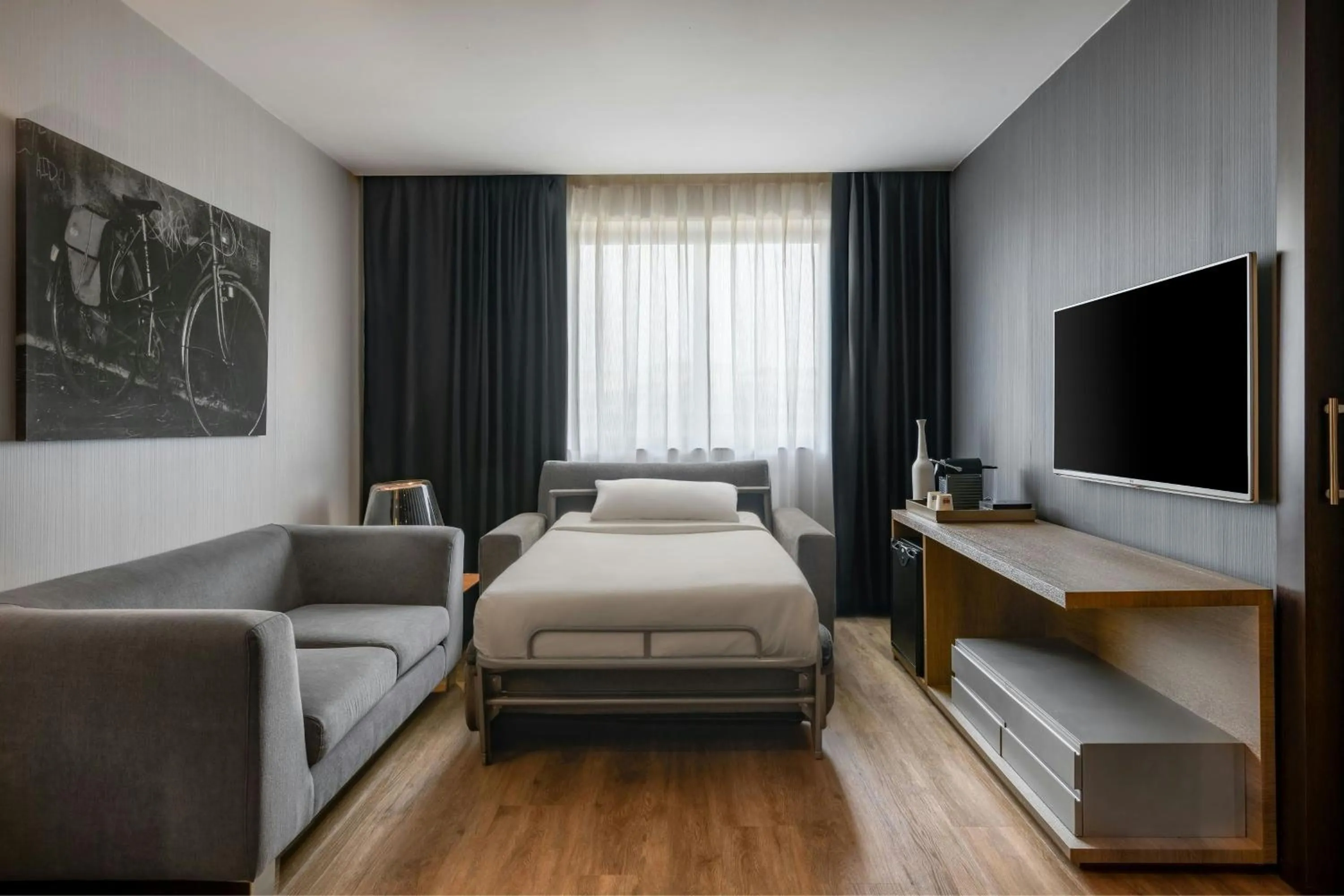 Living room, Bed in AC Hotel Madrid Feria by Marriott
