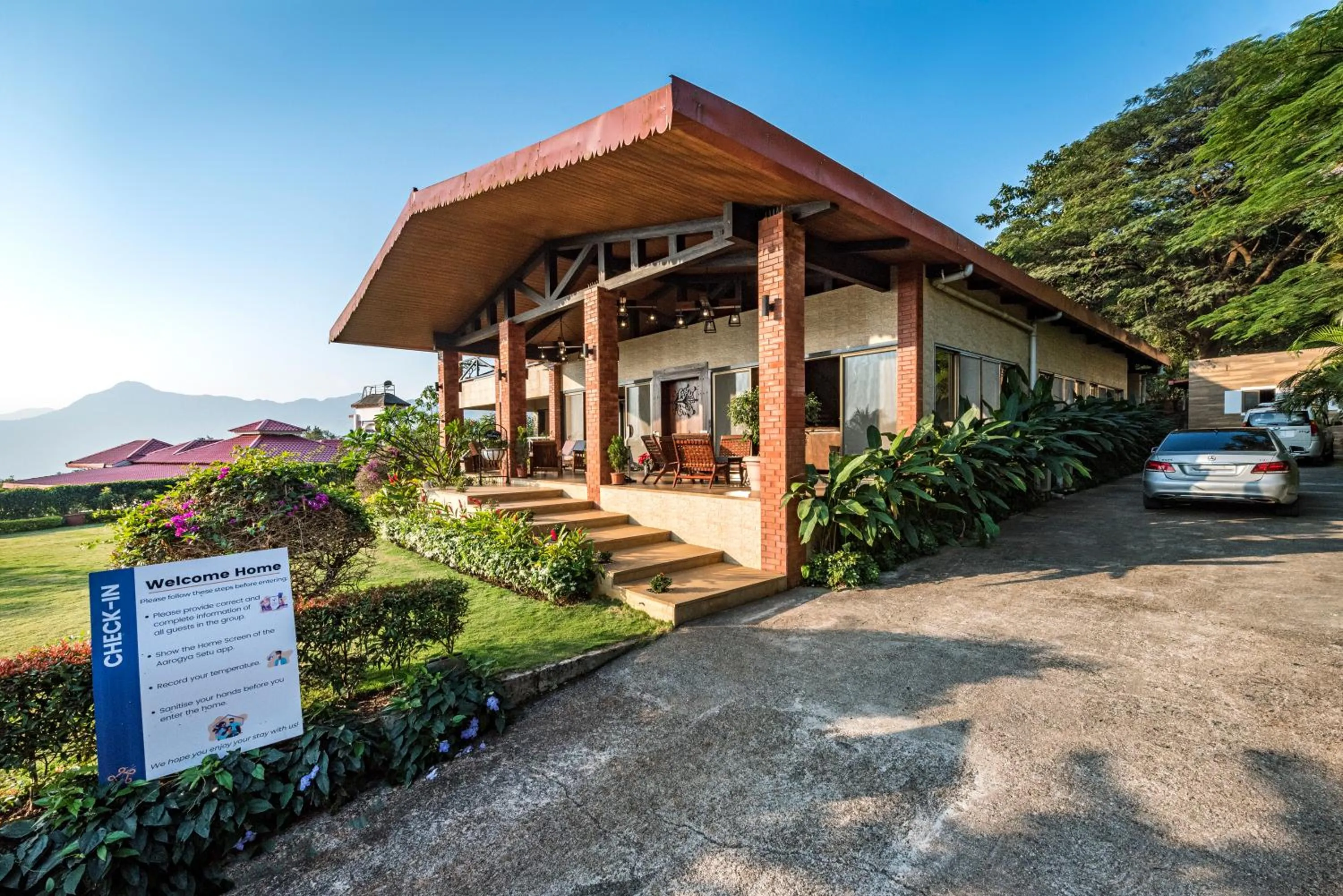 Property building in SaffronStays Althea - 4BR veg-only luxury villa with pool, jacuzzis, gourmet meals and Lohagad-Pawna lake views