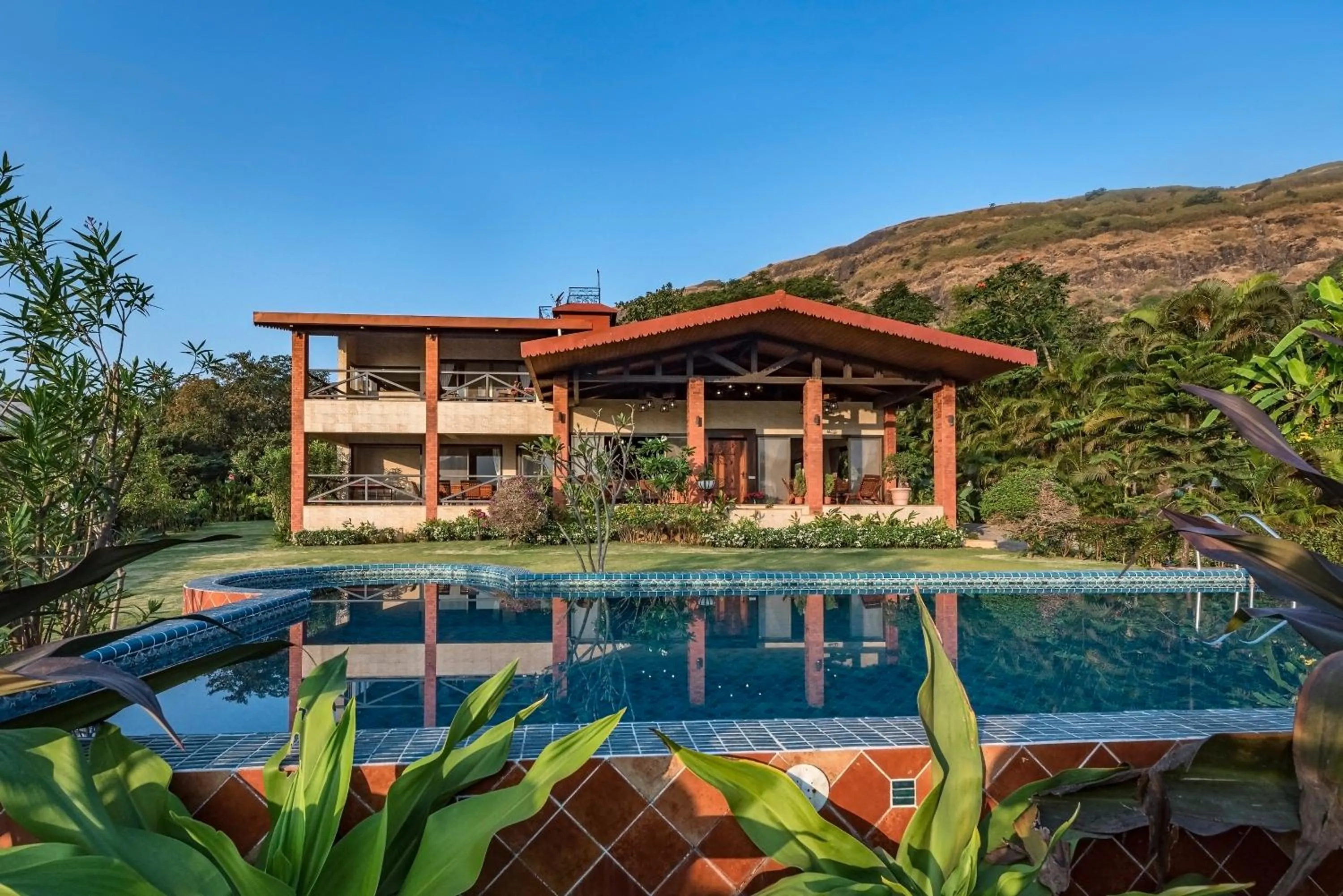 Property building in SaffronStays Althea - 4BR veg-only luxury villa with pool, jacuzzis, gourmet meals and Lohagad-Pawna lake views