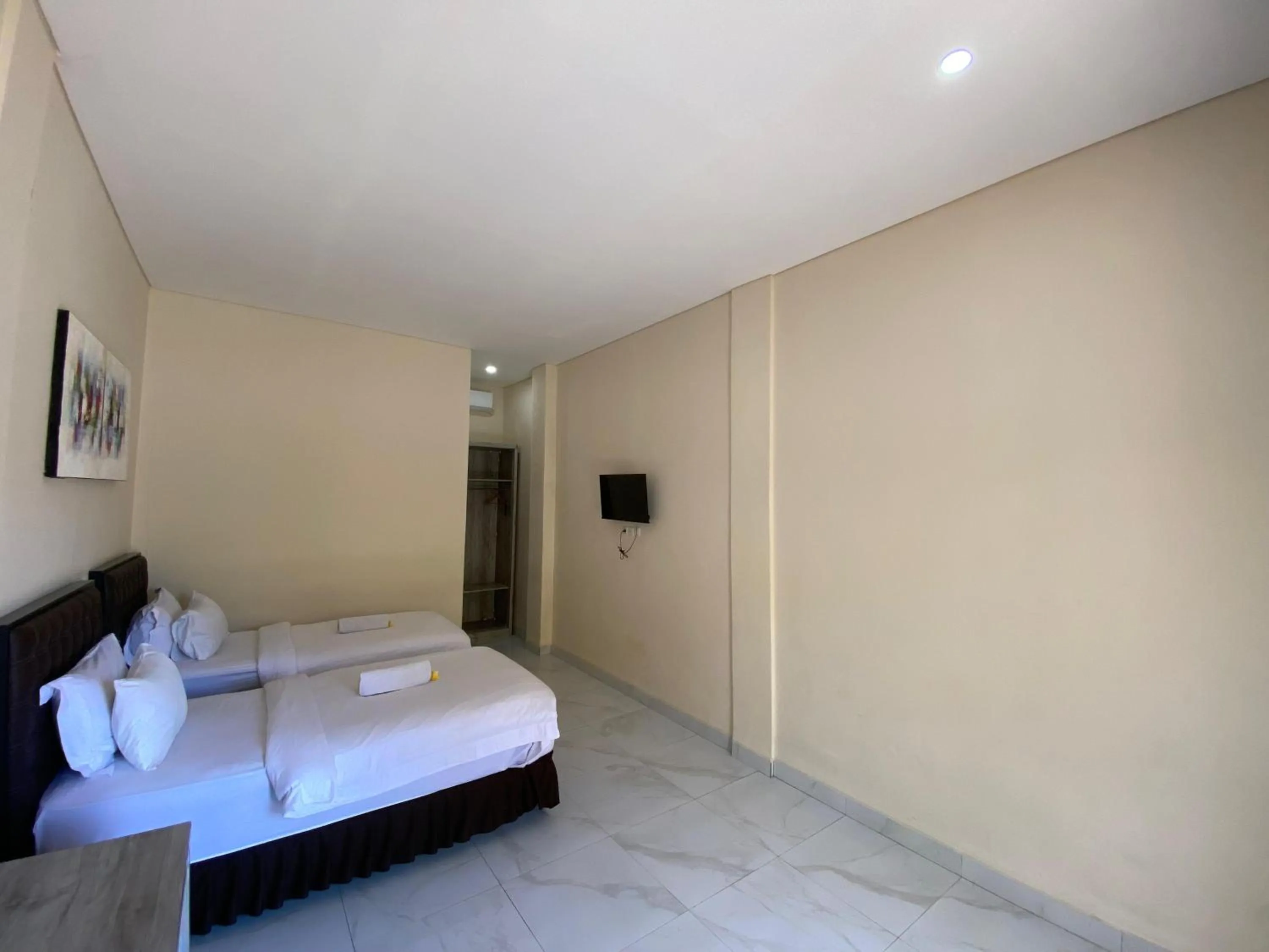 Bed in THE LAVIANA HOTEL