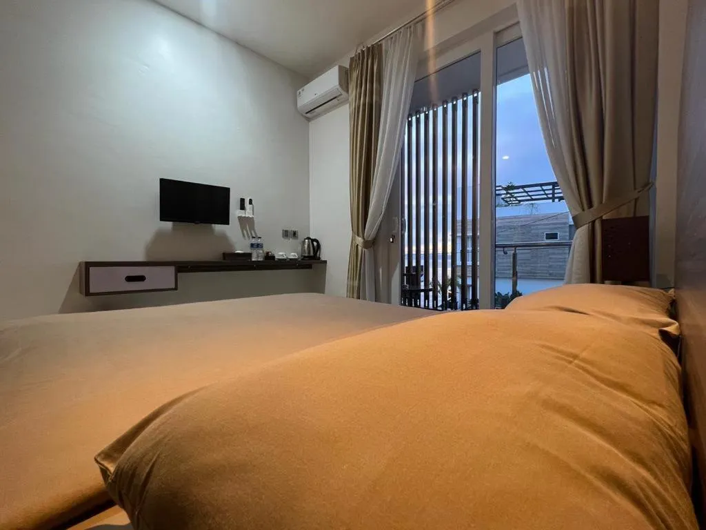 Bed in PURNAMA BALIGE HOTEL