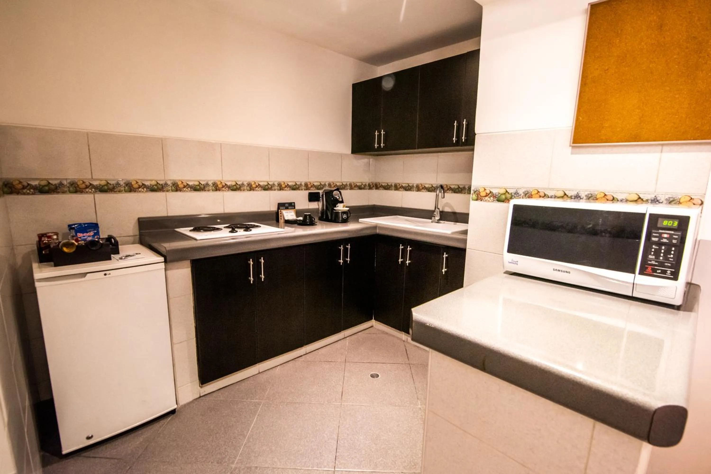 Kitchen or kitchenette in El Polo Hotel & Suites