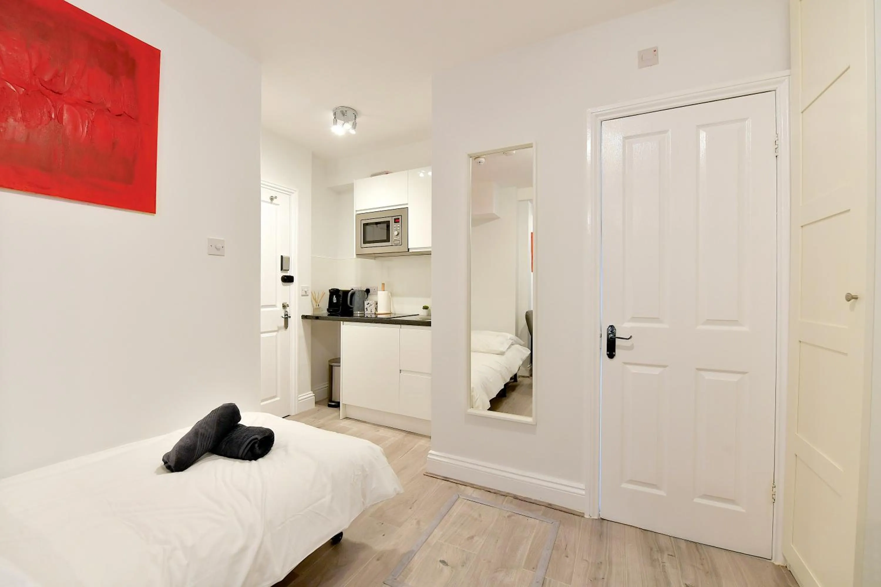 wardrobe, Bed in Stylish Studios by Luxestays Fulham