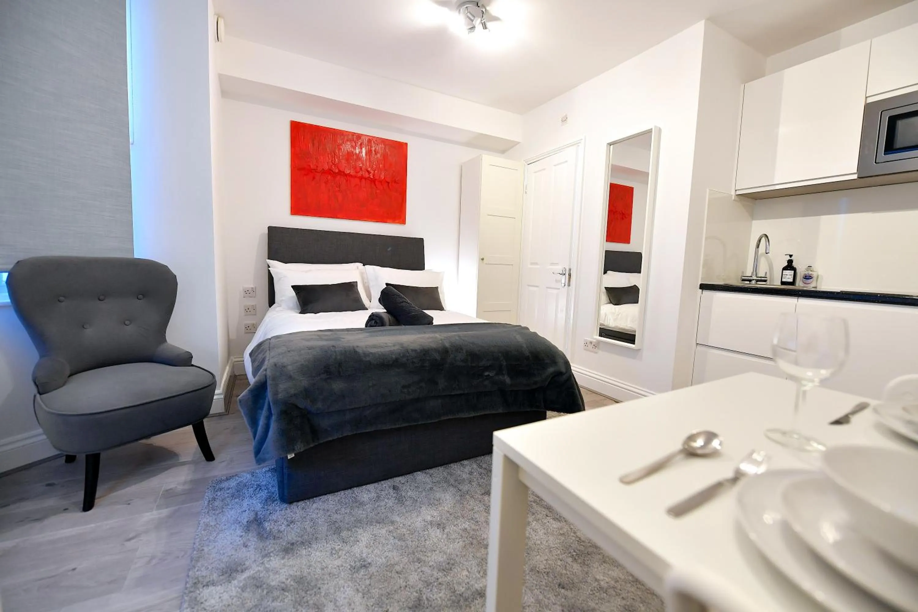 Seating area, Bed in Stylish Studios by Luxestays Fulham