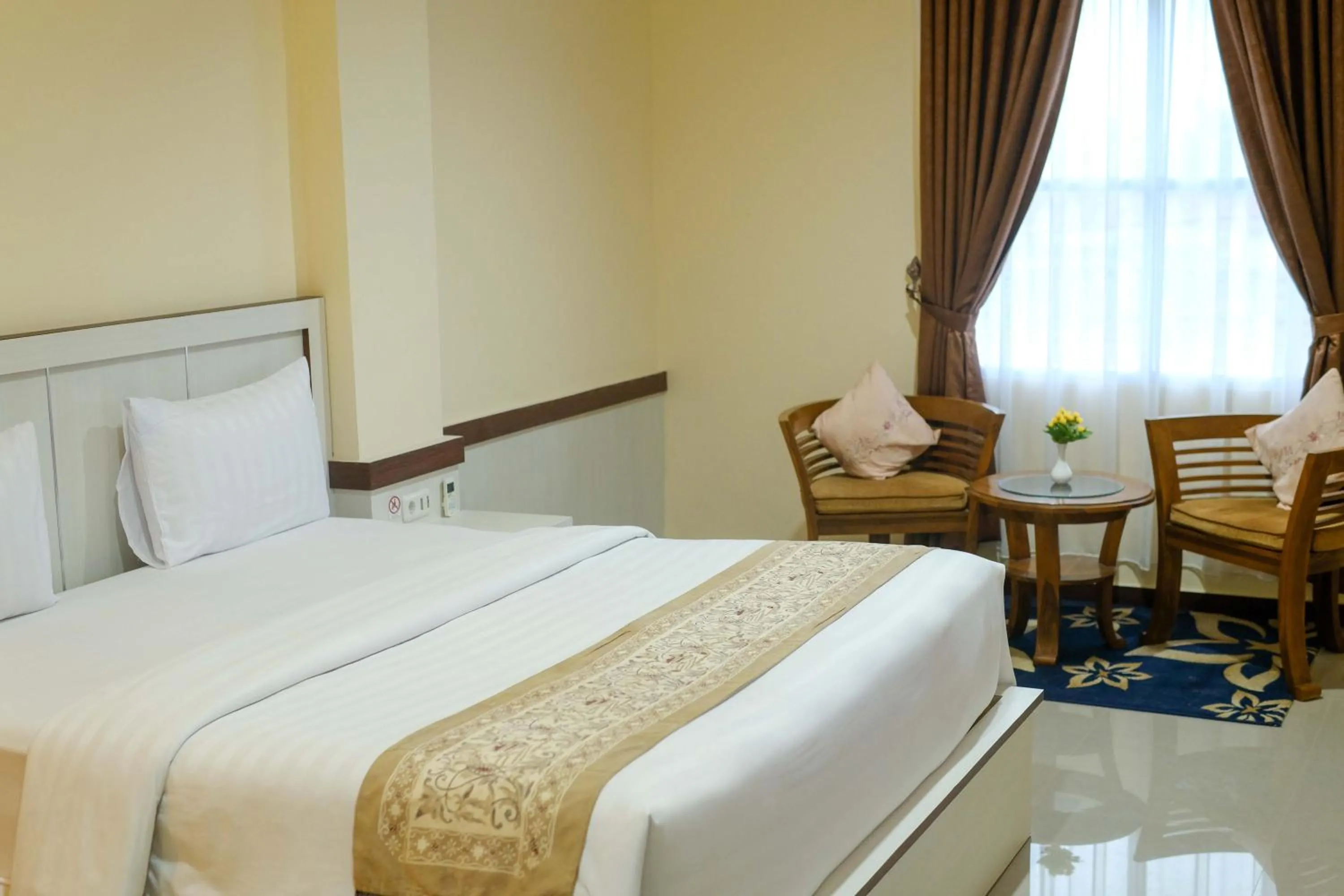 Bed in Grand Buana Lestari Hotel