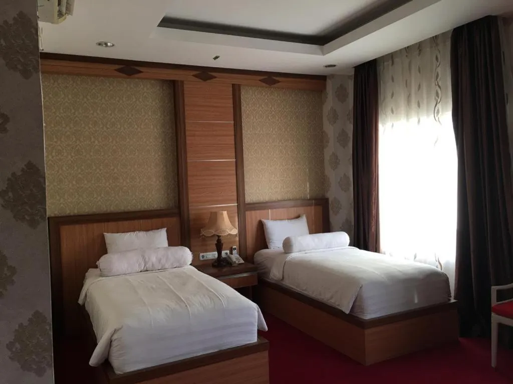 Bed in Grand Buana Lestari Hotel