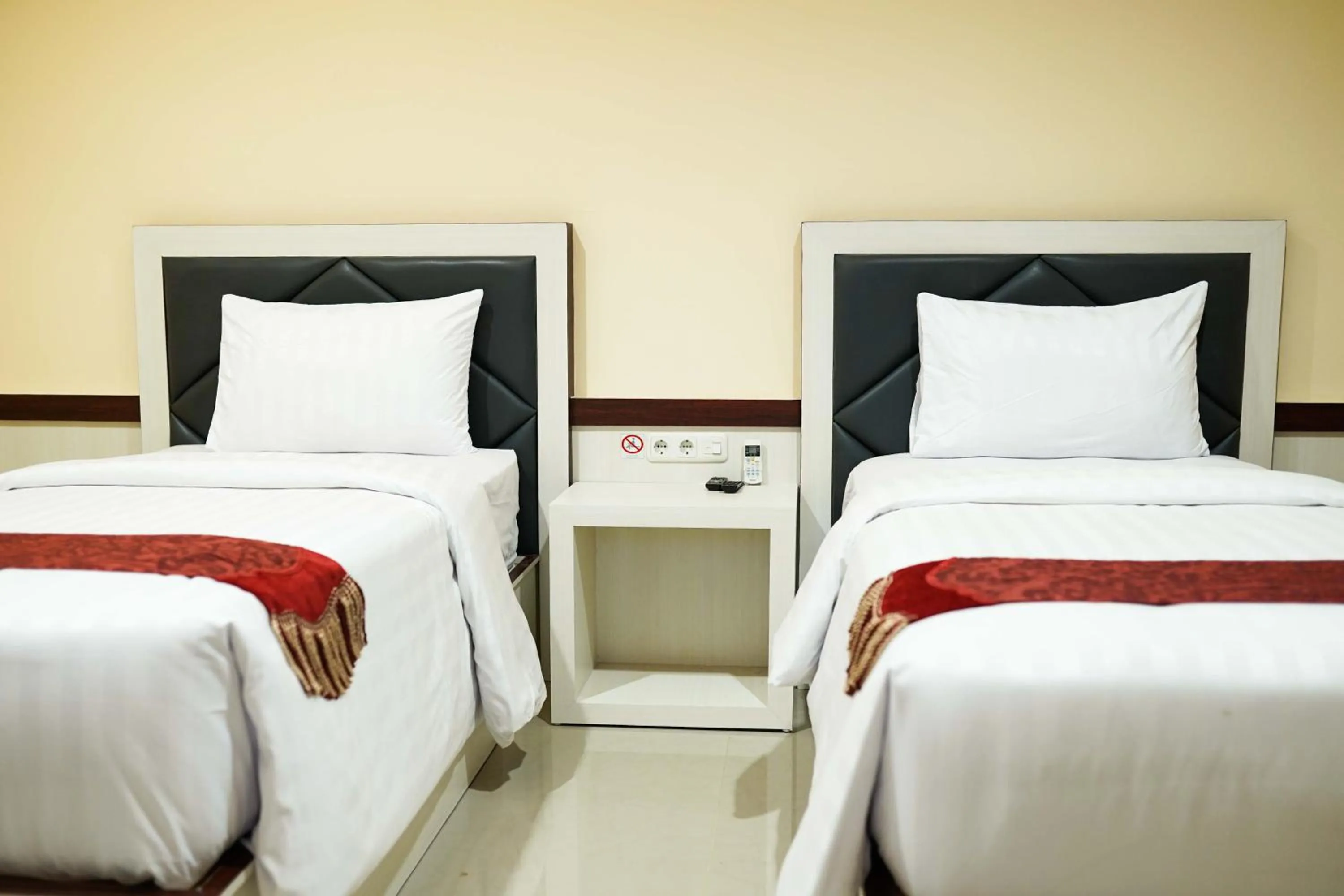 Bed in Grand Buana Lestari Hotel