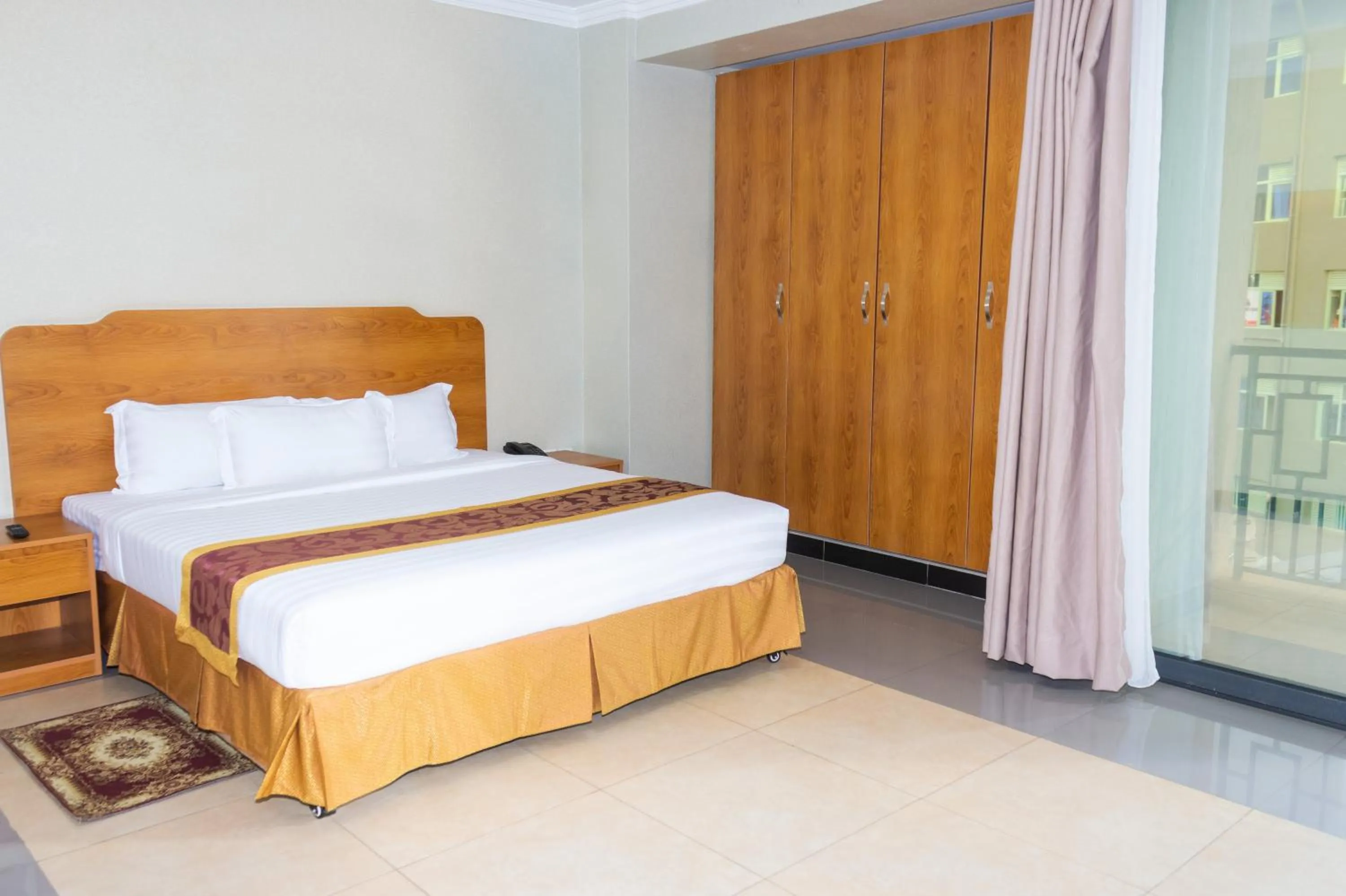 Bed in Tropical Plaza Apartments