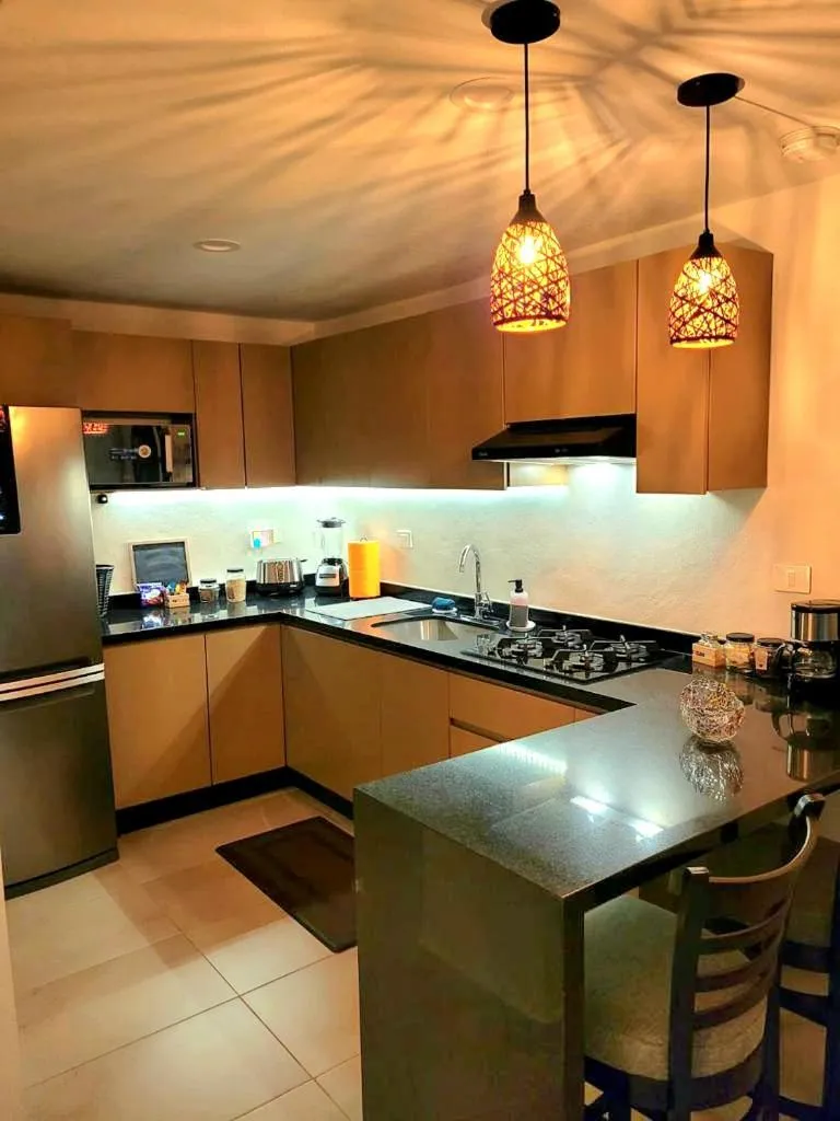 kitchen in Departamento Céntrico y Moderno en Cancún.