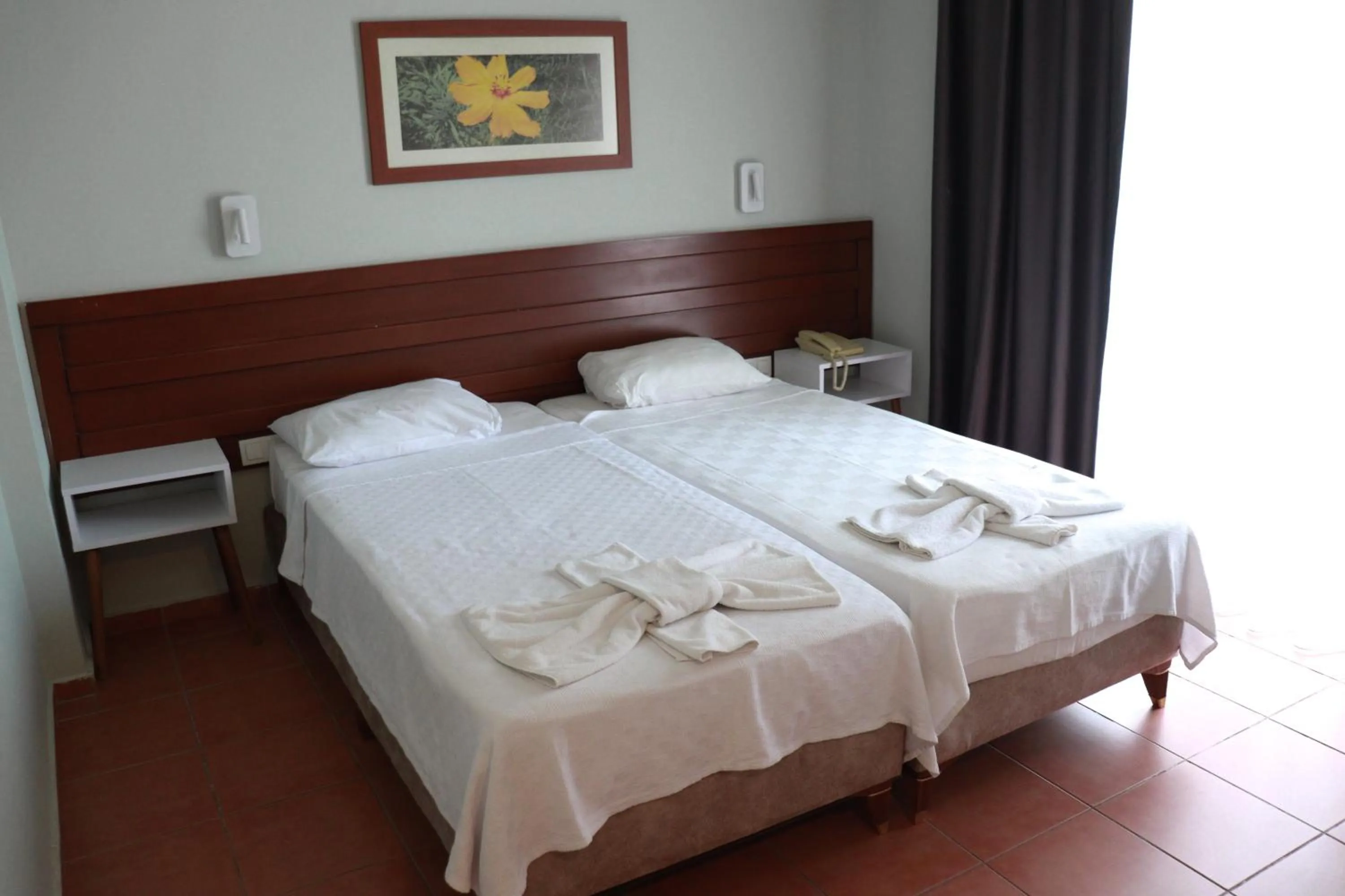 Bed in LEMAS SUITE HOTEL