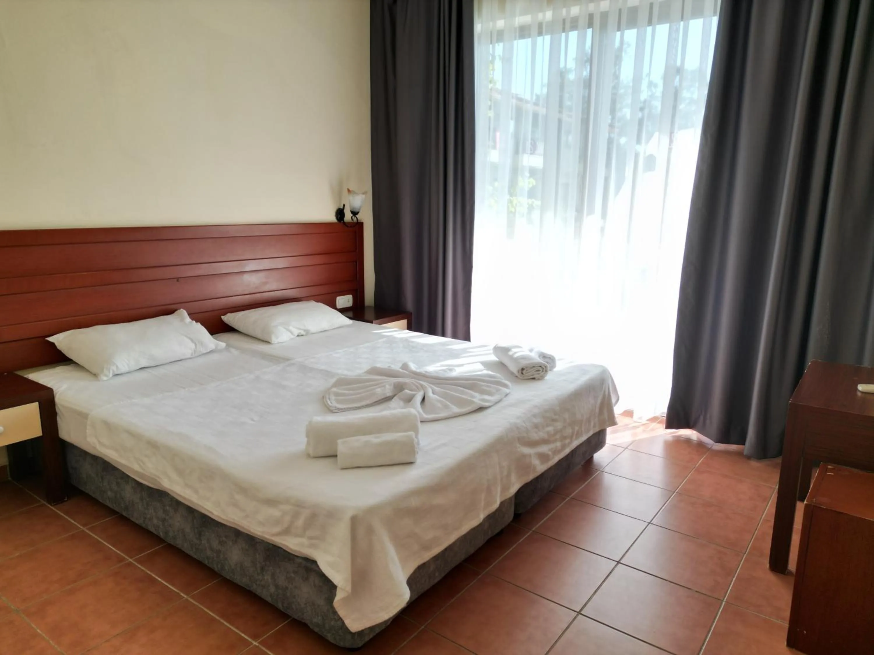 Bed in LEMAS SUITE HOTEL