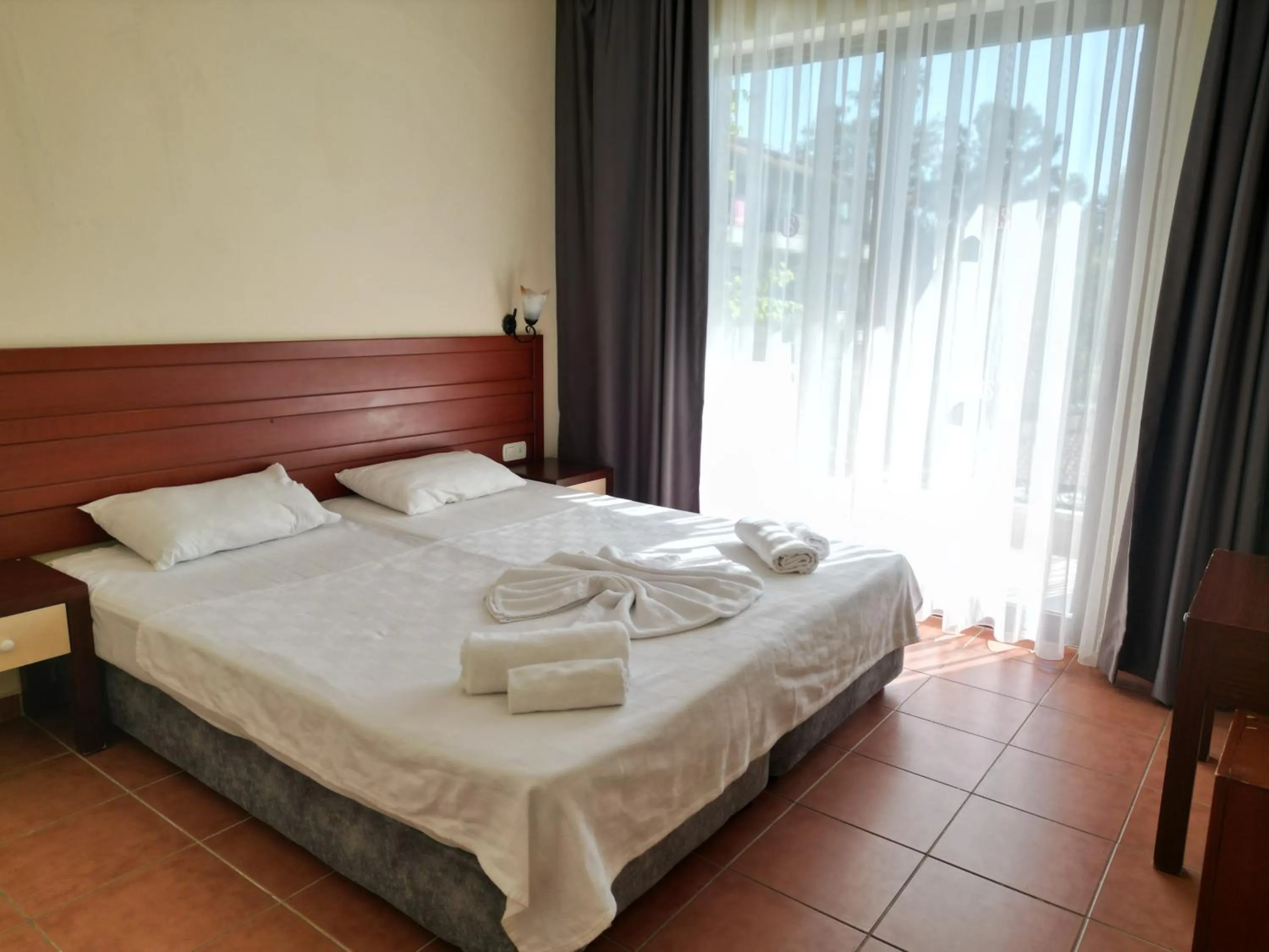 Bed in LEMAS SUITE HOTEL