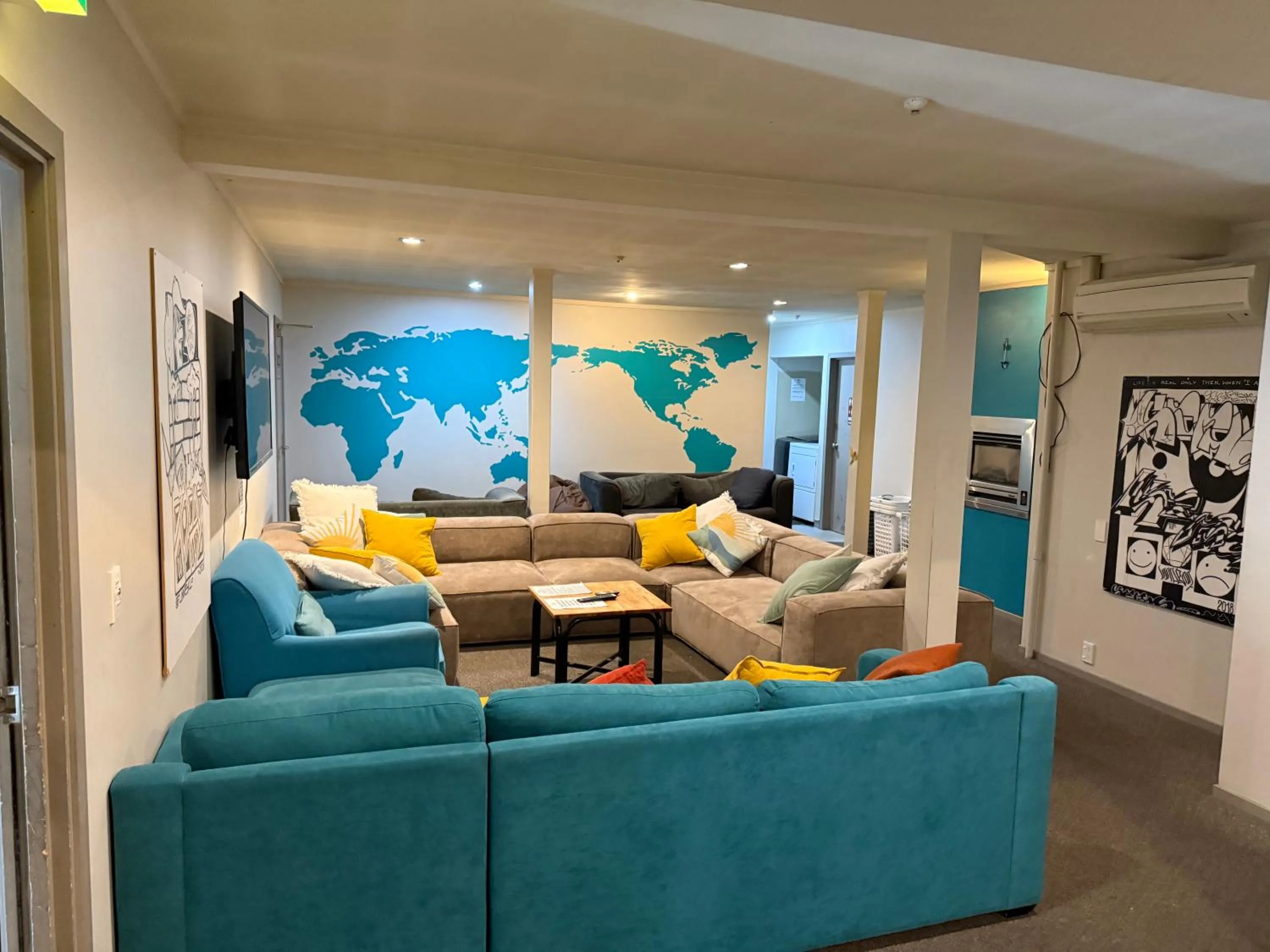 Communal lounge/ TV room in UpTown Backpackers