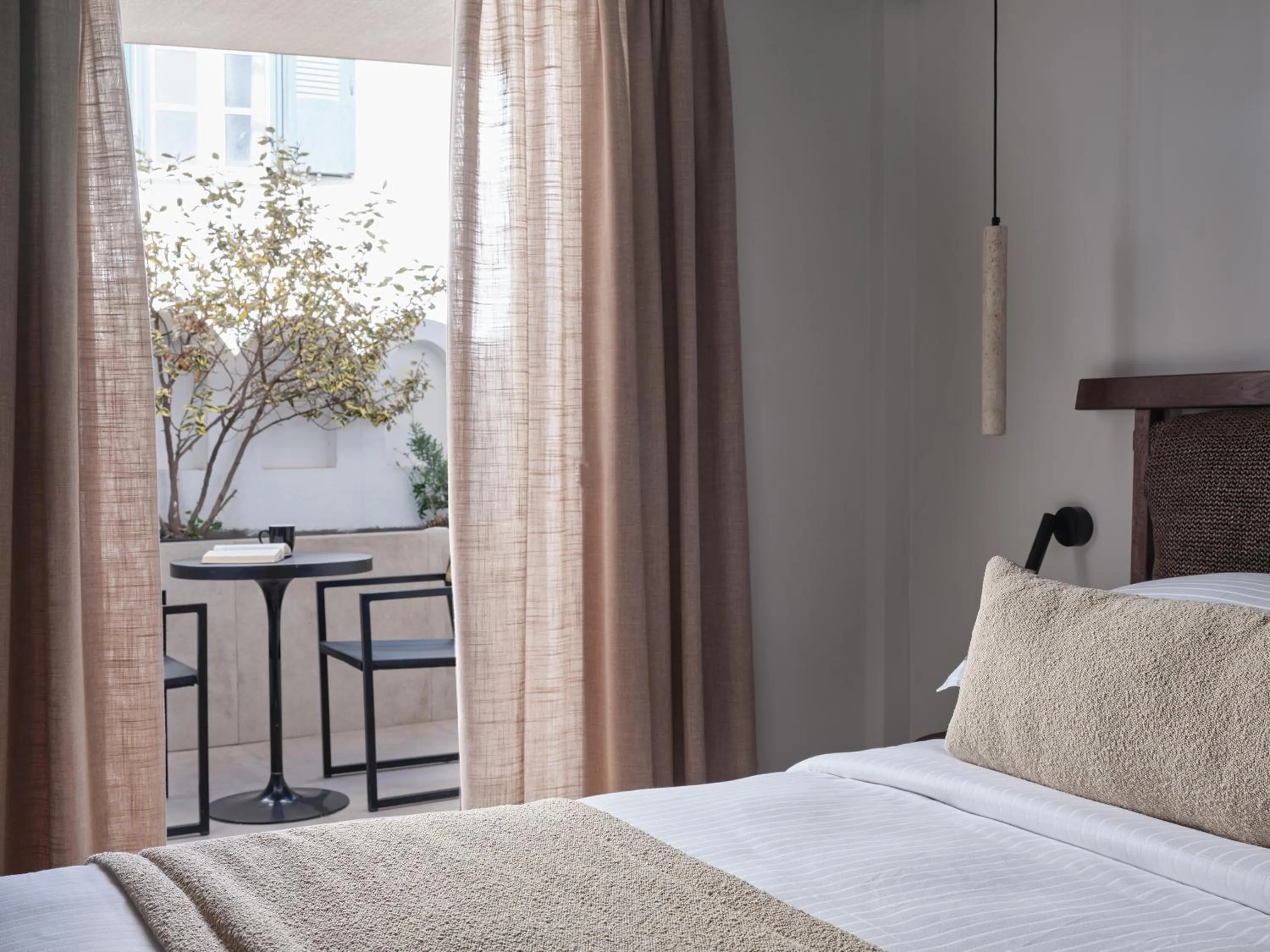 Bed in Loizos Stylish Residences