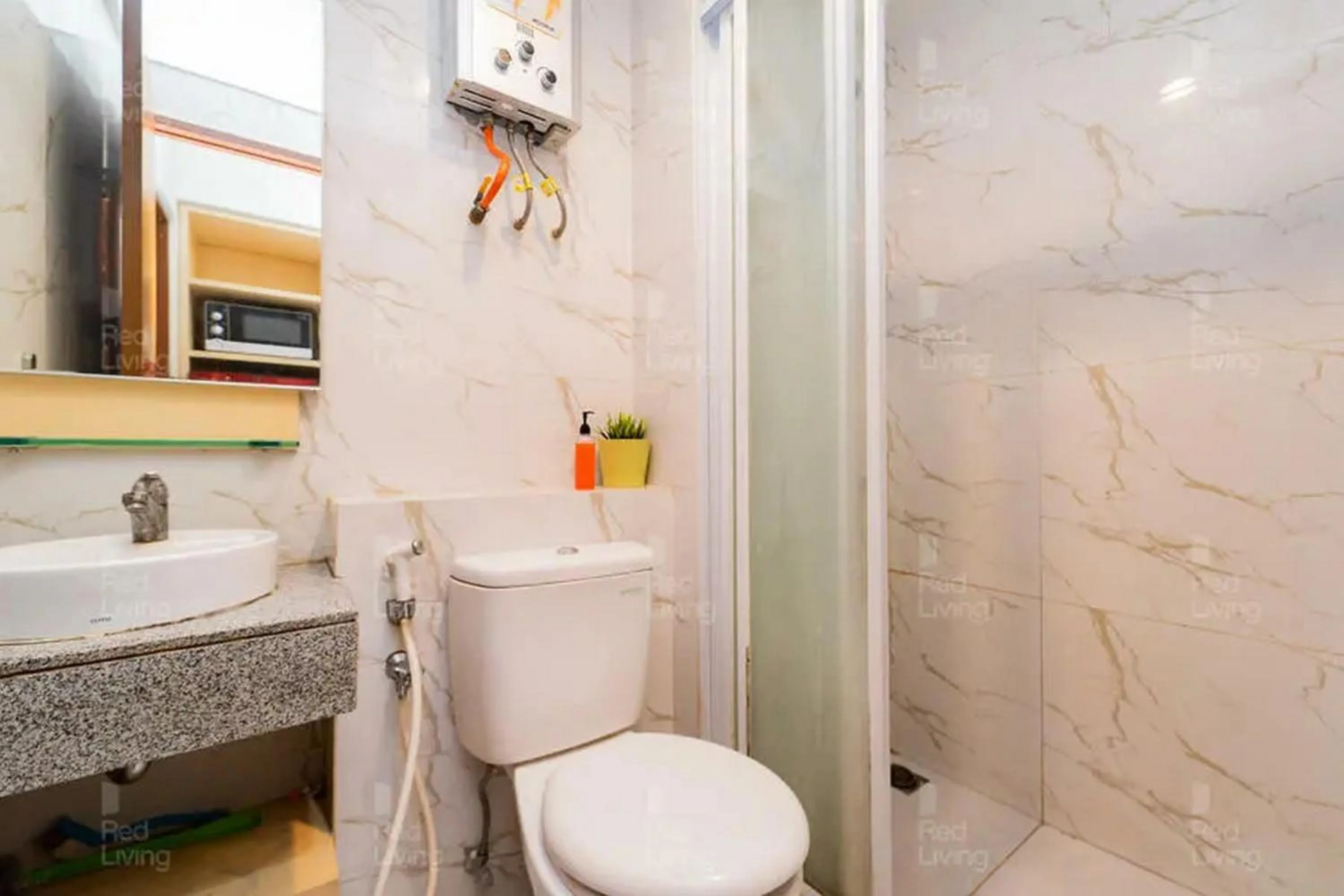 Bathroom in RedLiving Apartemen Grand Kamala Lagoon - Icha Rooms Tower Barclay South with Netflix