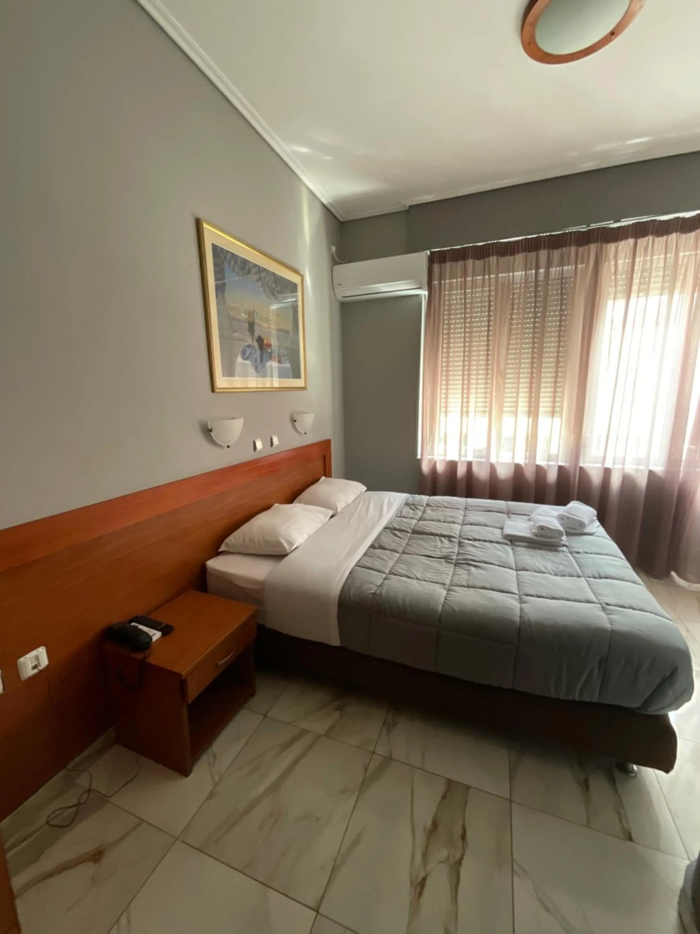 Bed in Piraeus Acropole Hotel