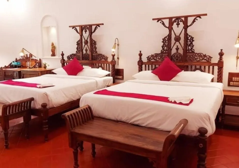 Bed in Marari Beach Bungalow Resort Alleppey