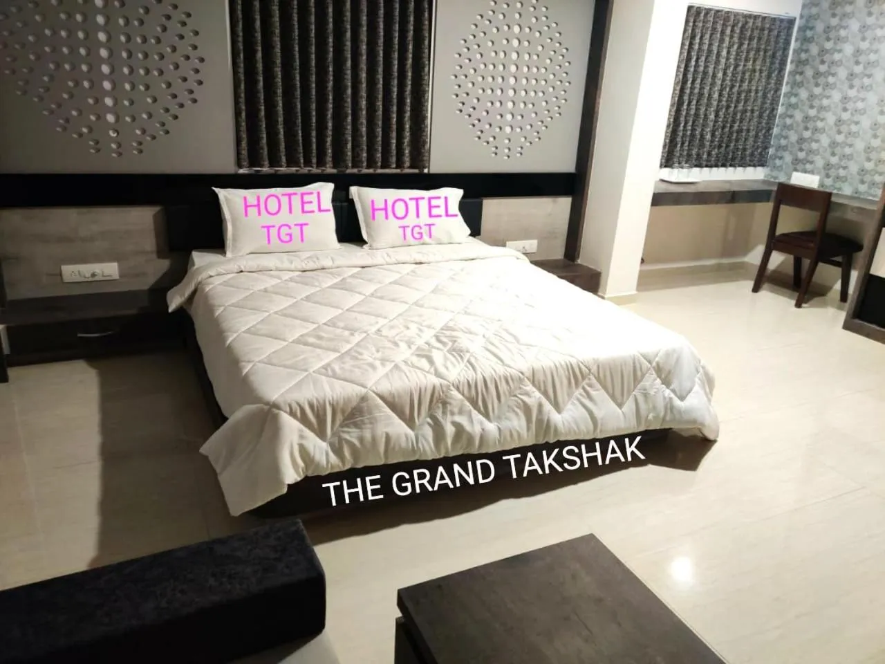 Bed in The Grand Takshak Hotel