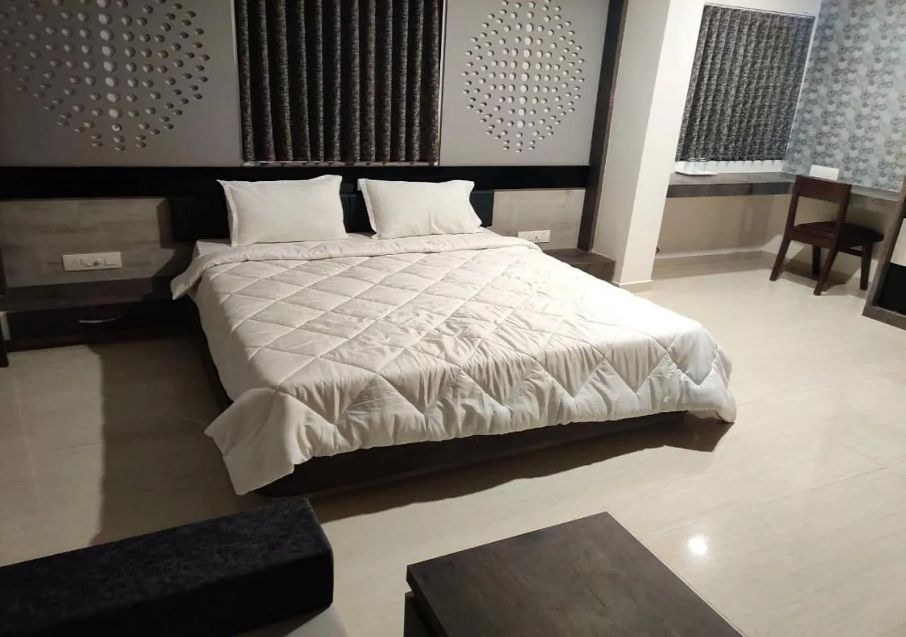 Bed in The Grand Takshak Hotel