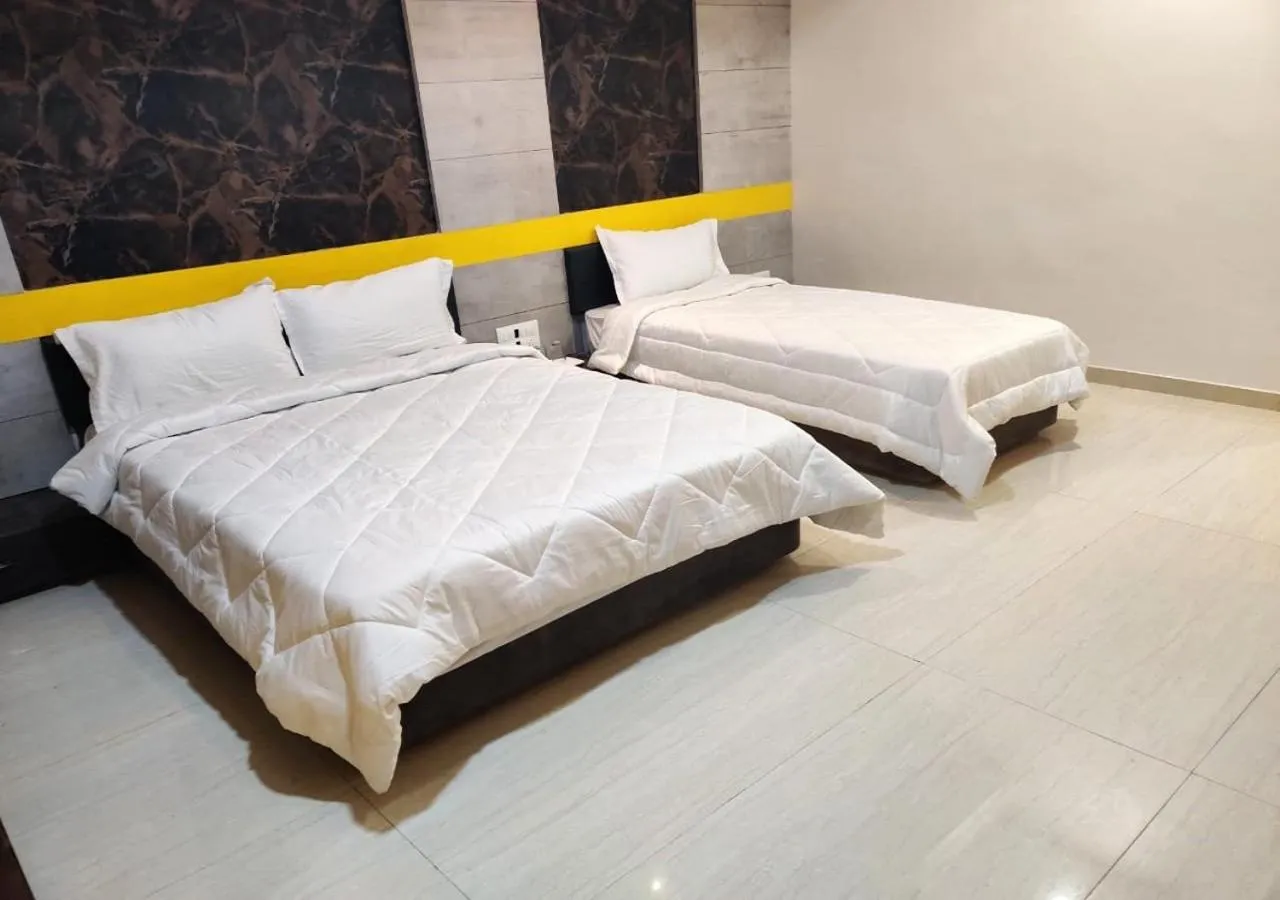 Bed in The Grand Takshak Hotel