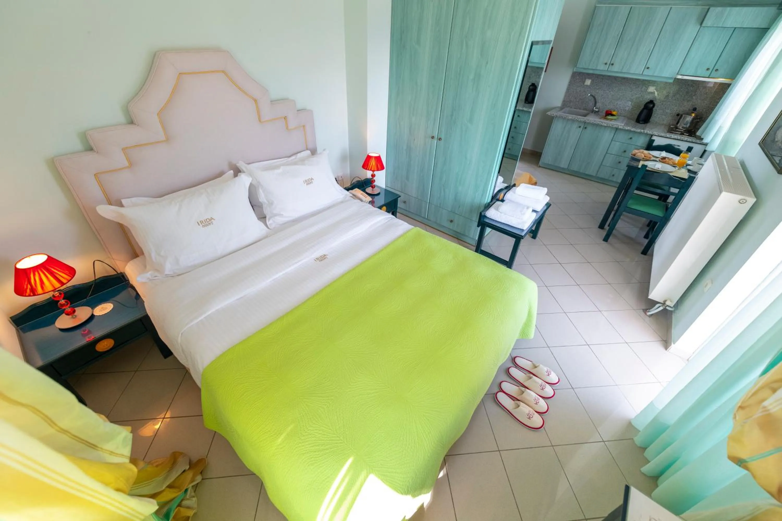 Kitchen or kitchenette, Bed in Irida Beach Resort Suites