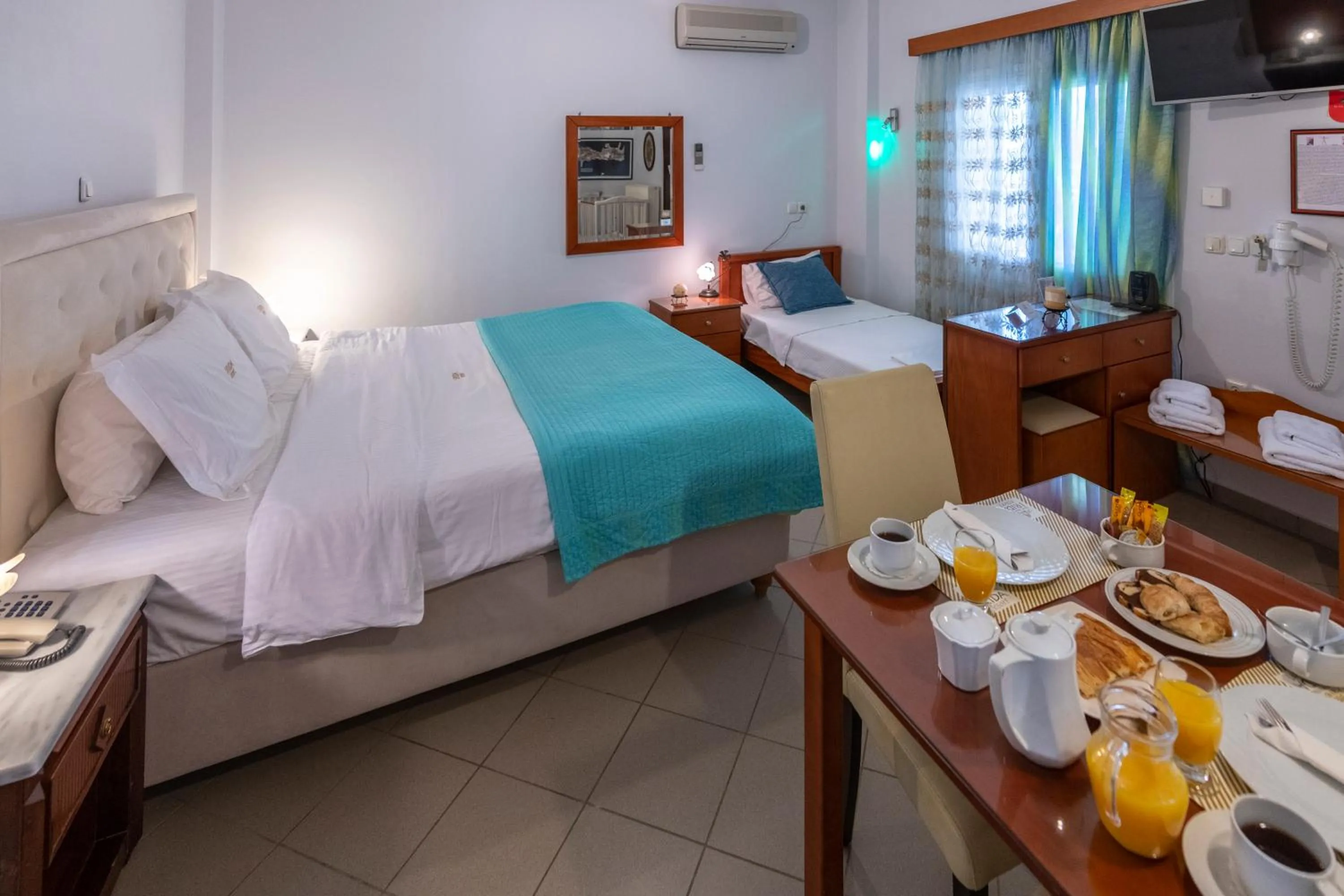 Bed in Irida Beach Resort Suites