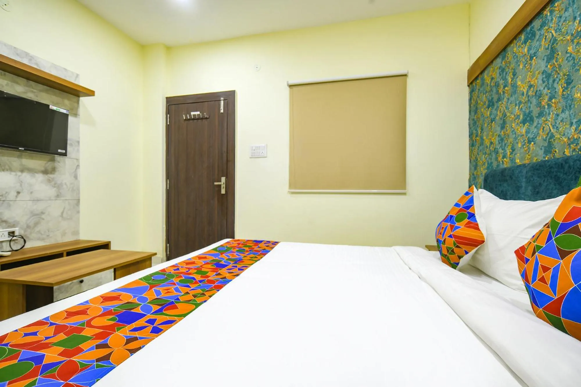 Bed in FabHotel Grand Giriraj