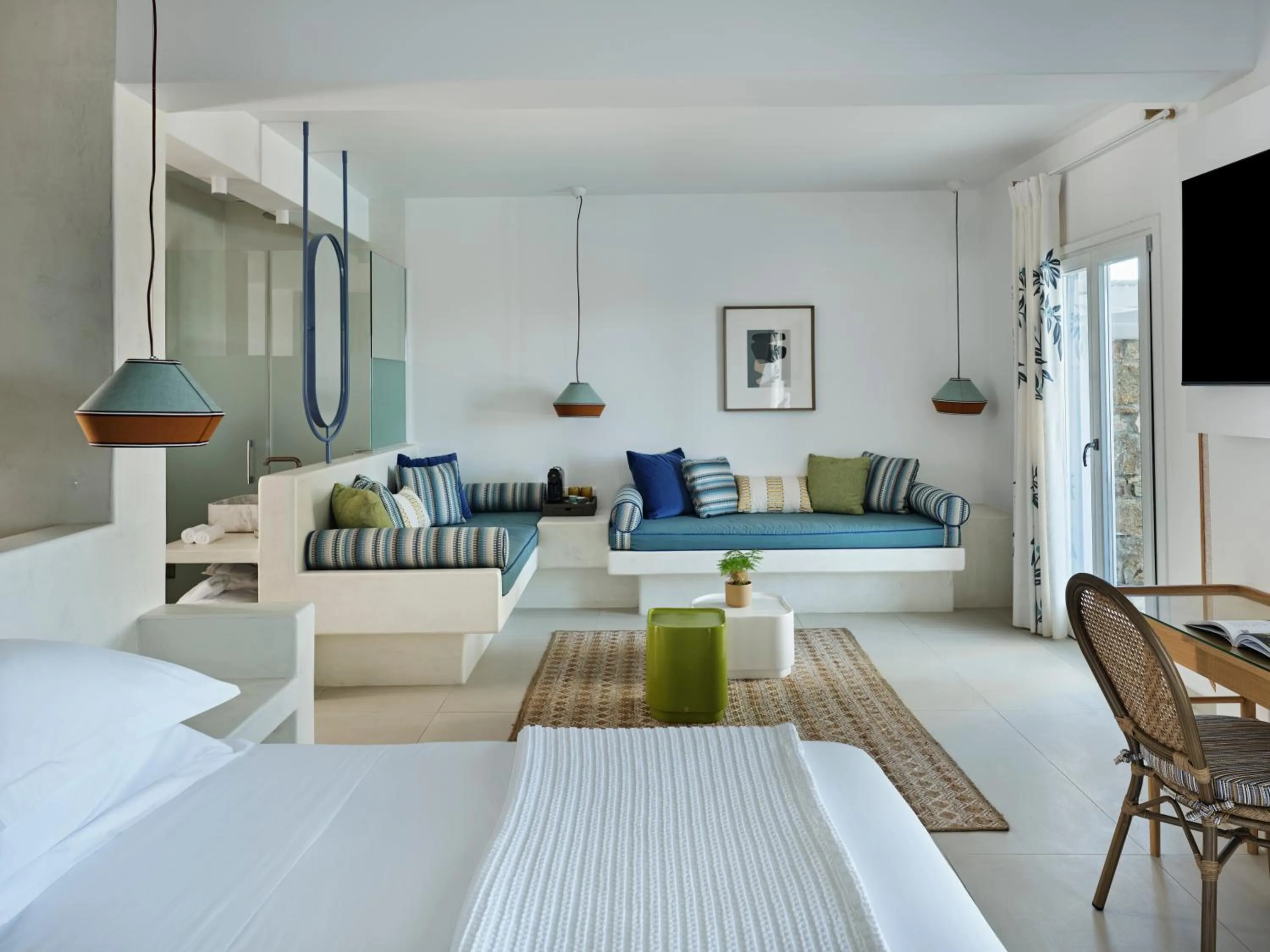 Bed in Myconian Sunrise Relais & Chateaux Hotel