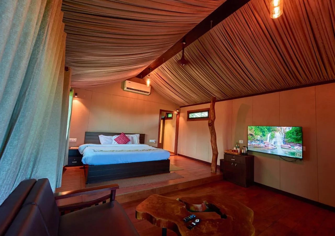 Communal lounge/ TV room, Bed in Niyatma Wayanad Pool Resort by VOYE HOMES - Inside Coffee Plantation