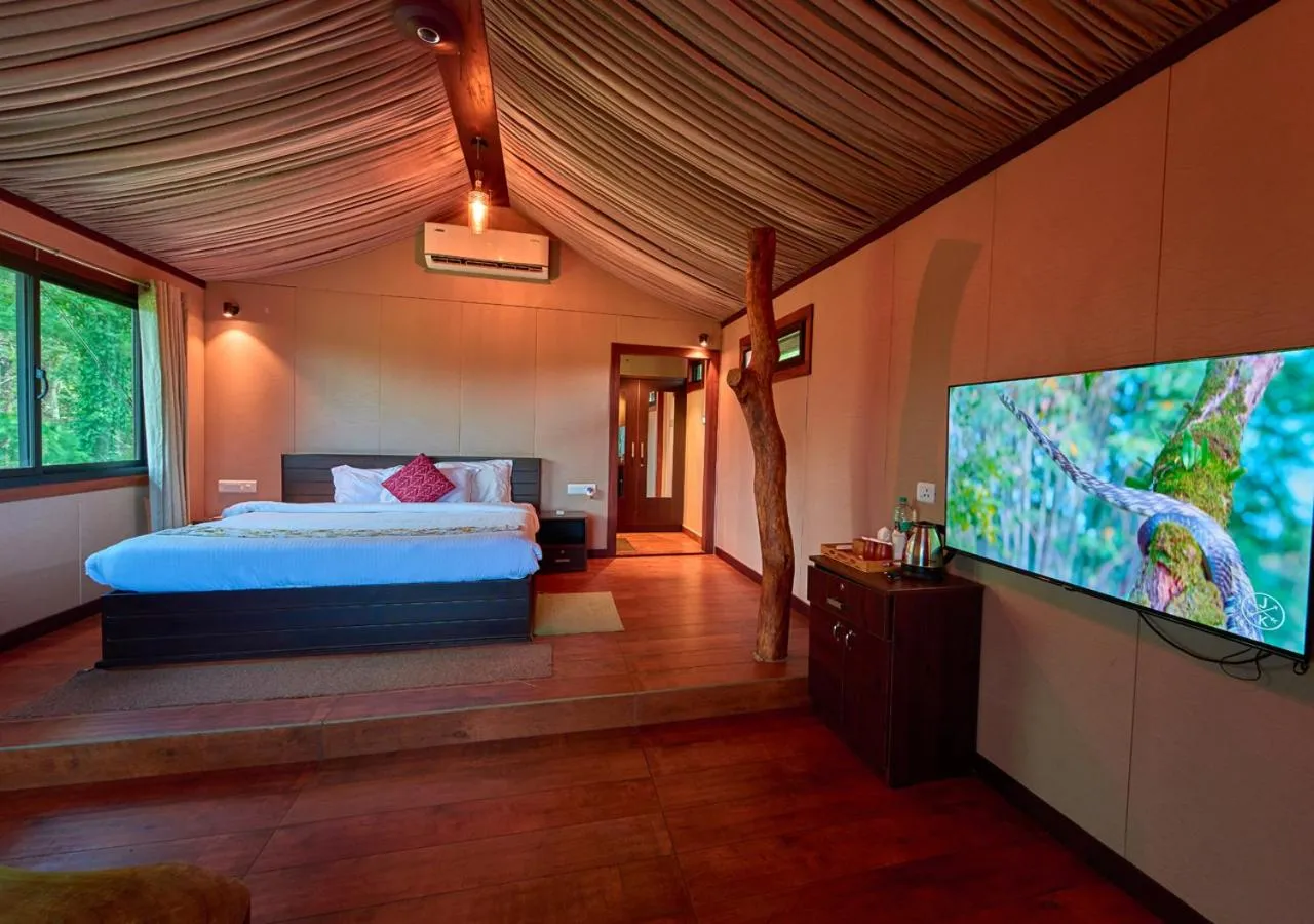 Communal lounge/ TV room, Bed in Niyatma Wayanad Pool Resort by VOYE HOMES - Inside Coffee Plantation