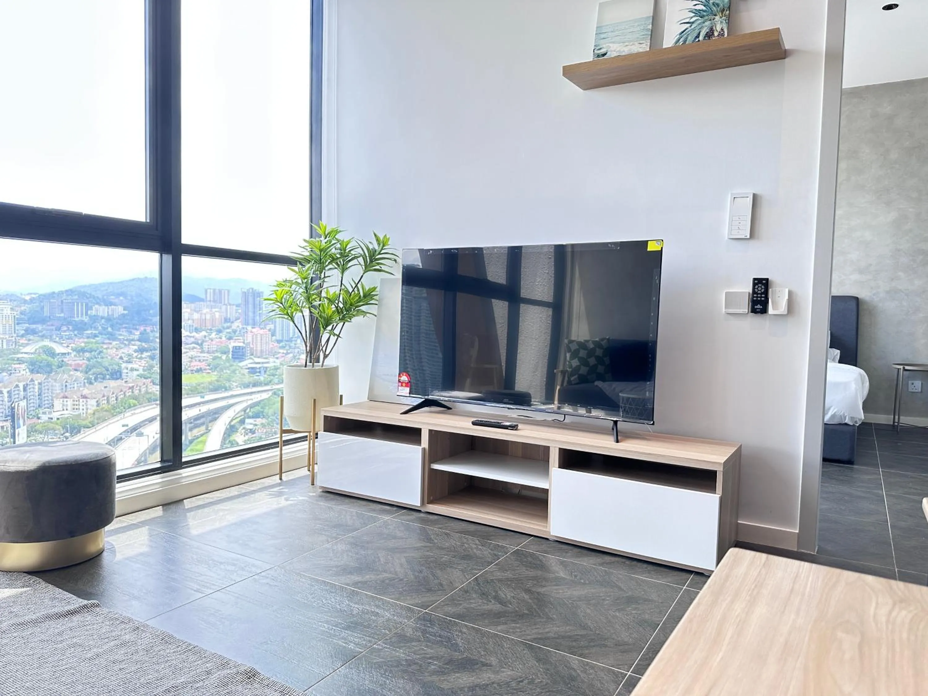 Communal lounge/ TV room in Scarletz Suites KLCC Twin Tower by Purple Orchid