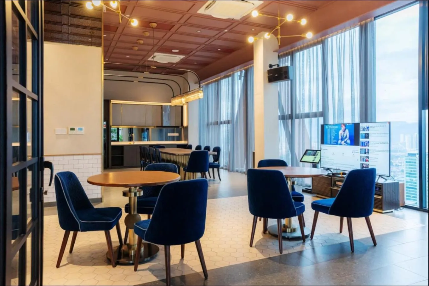 Communal lounge/ TV room in Scarletz Suites KLCC Twin Tower by Purple Orchid