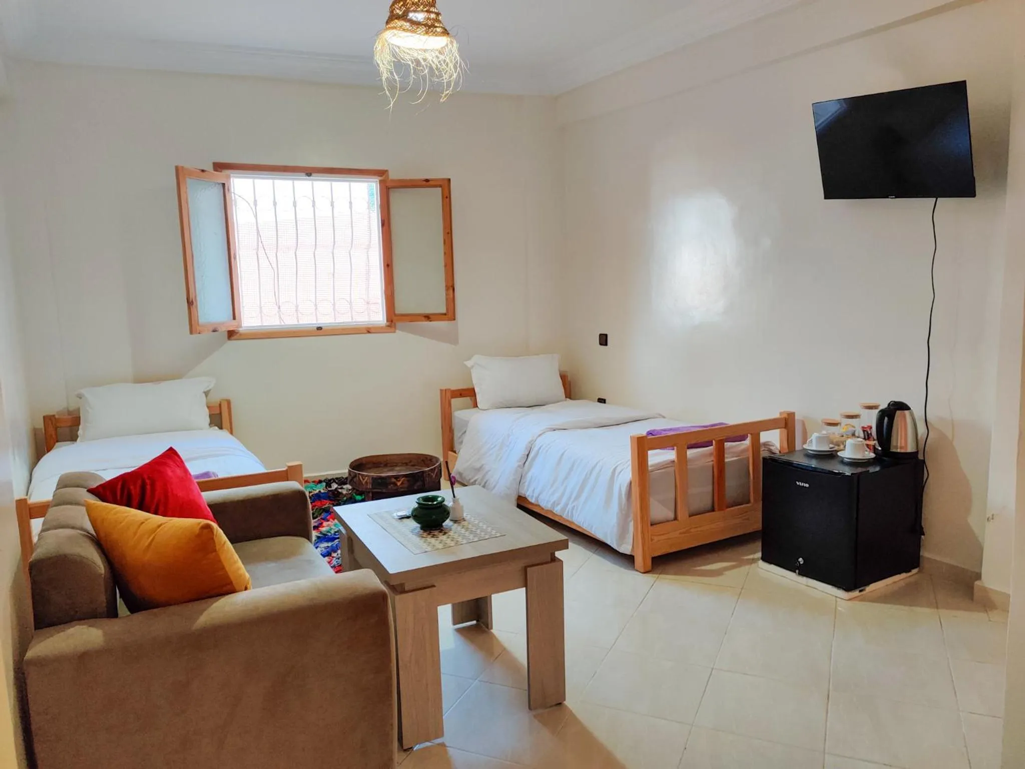 Communal lounge/ TV room, Bed in Locals Taghazout surfcamp