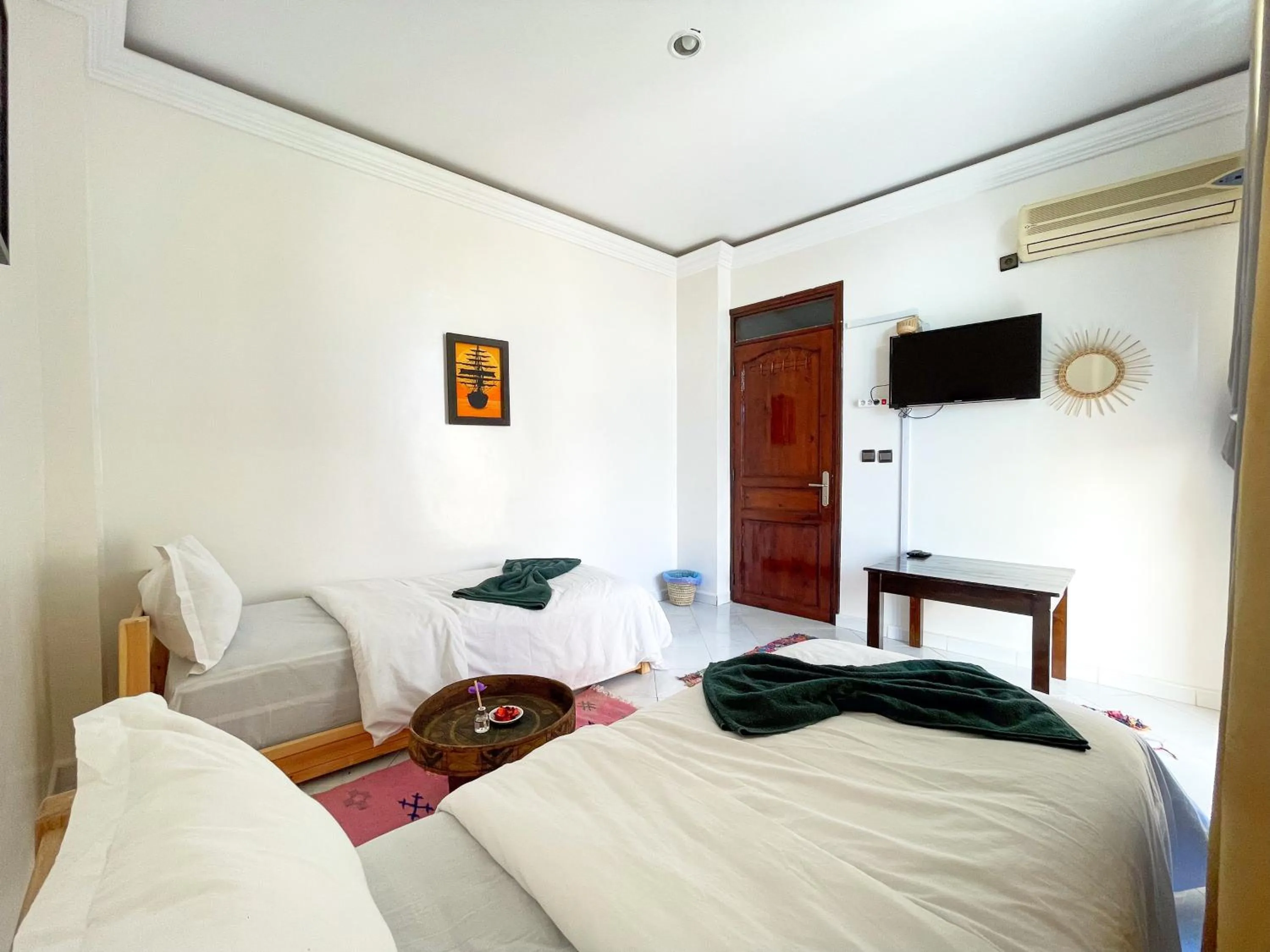 Communal lounge/ TV room, Bed in Locals Taghazout surfcamp