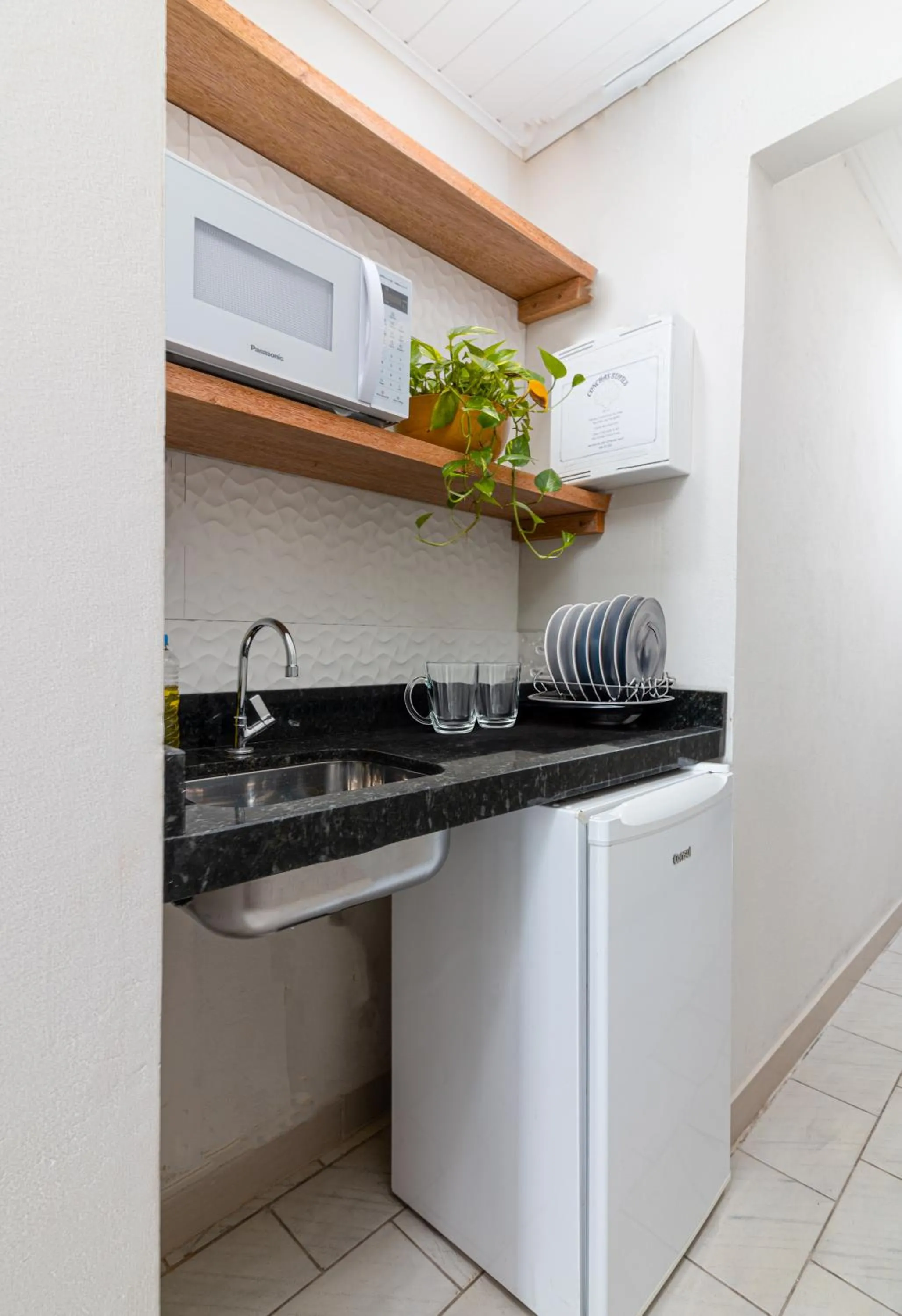 Kitchen or kitchenette in Suítes 91